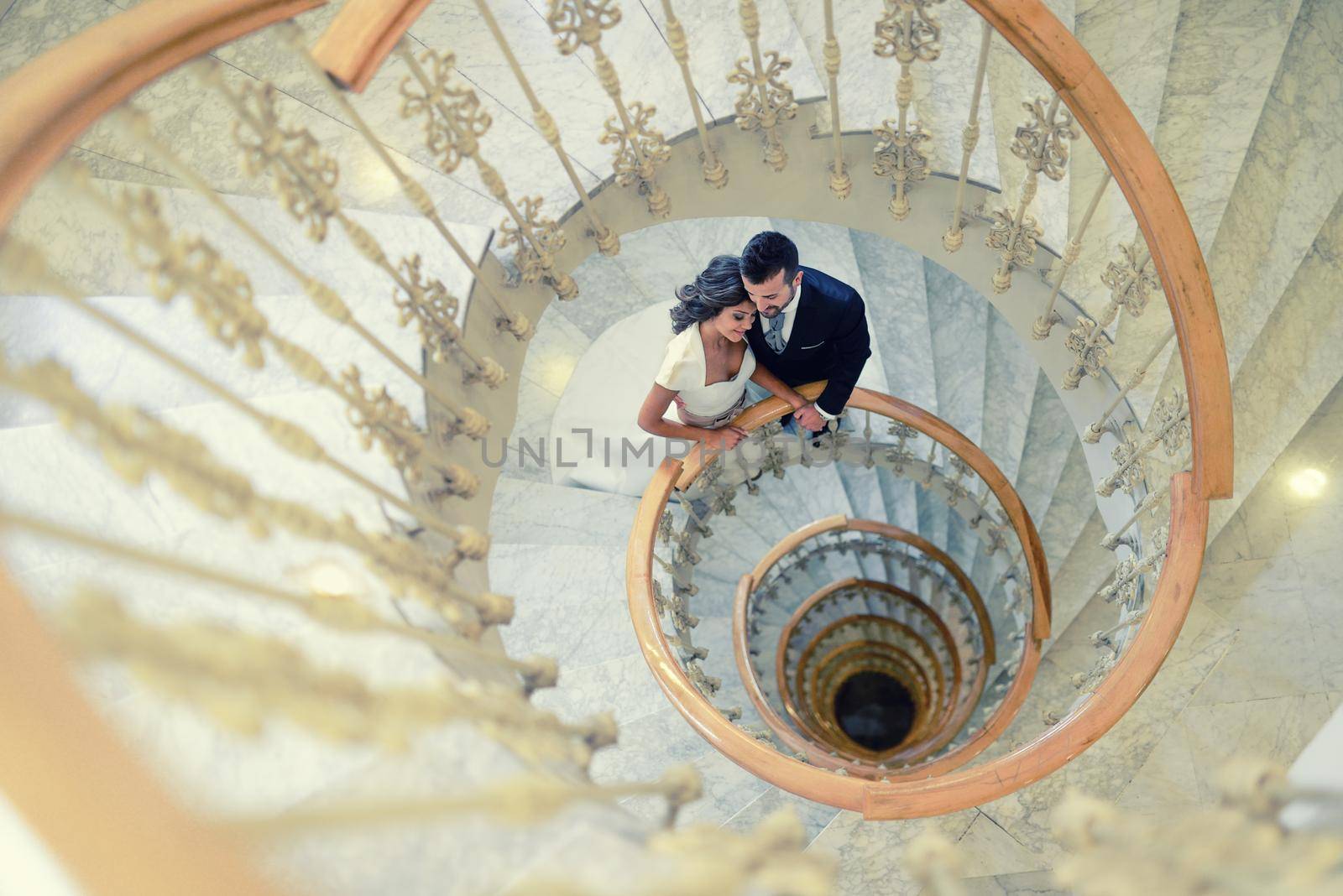 Just married couple in a spiral staircase by javiindy