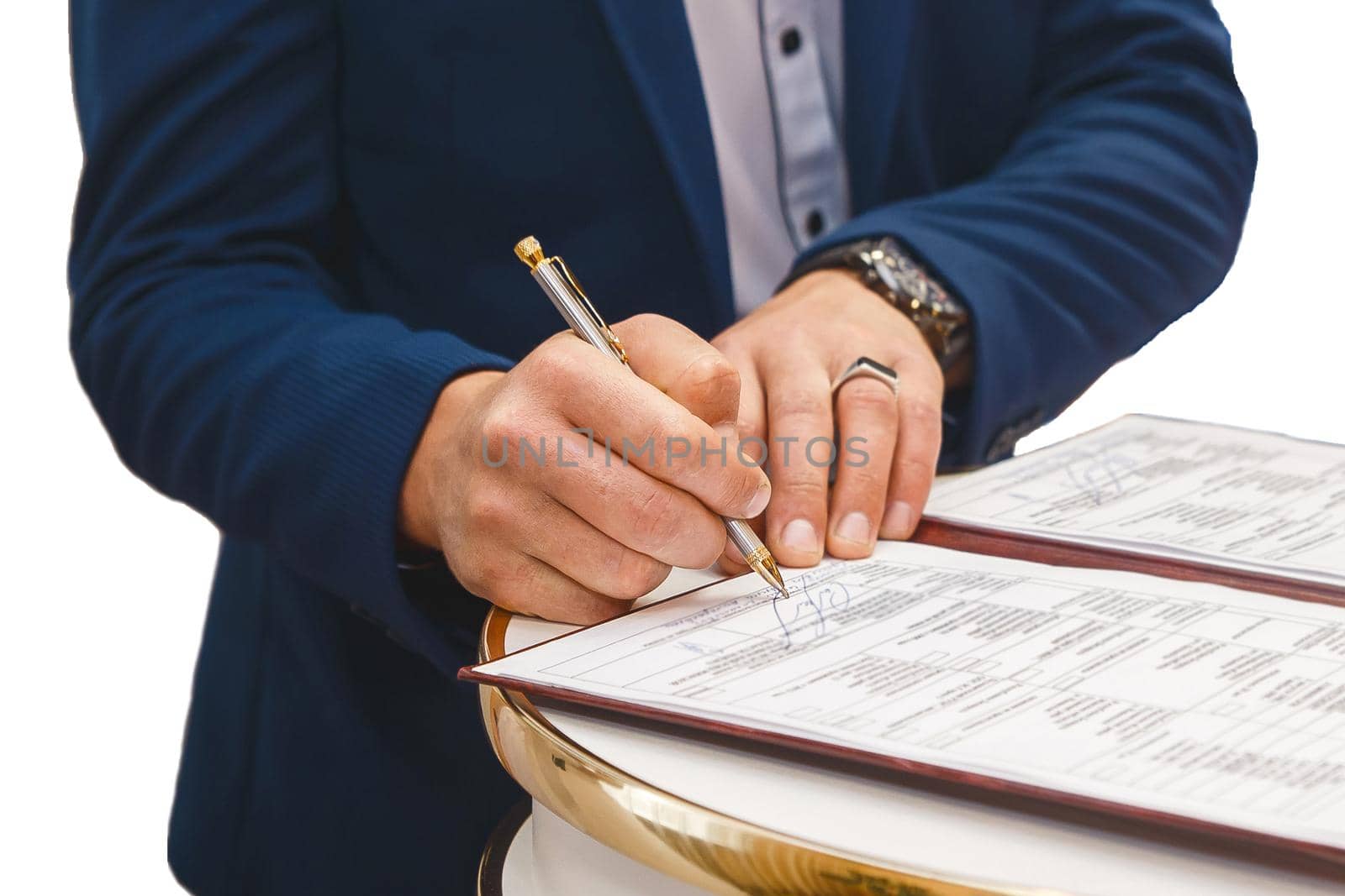 Groom's man's hands put on the signature in the magazine about consent to marriage at the wedding.