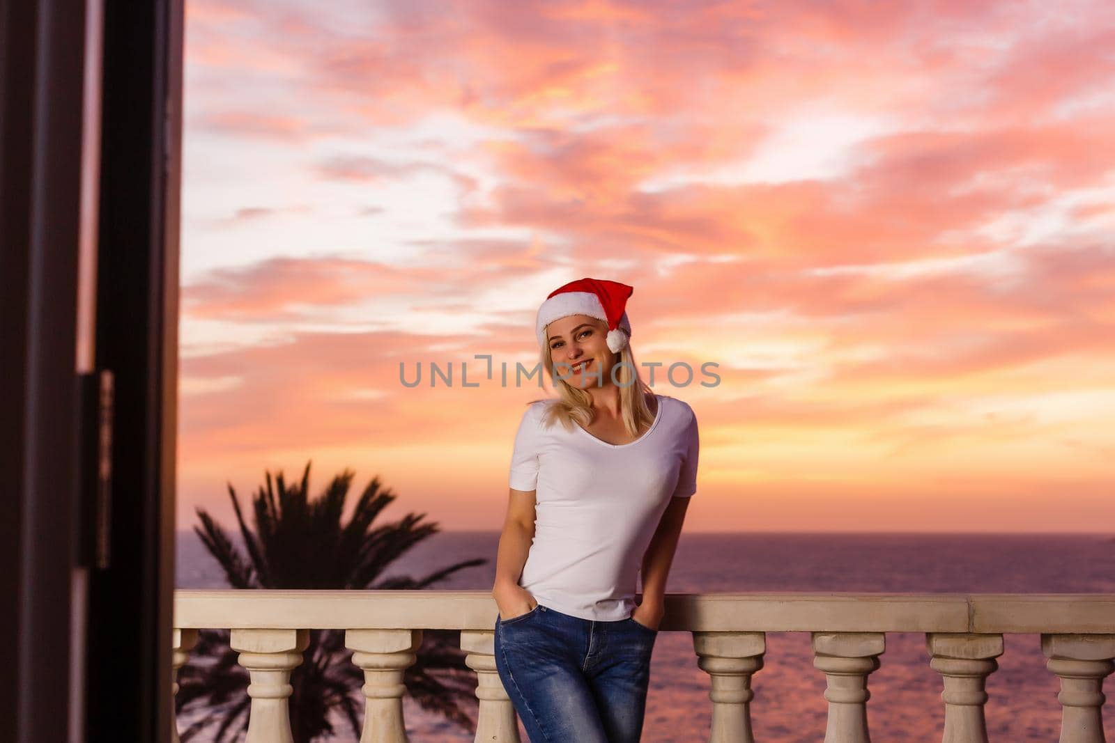 Woman admiring sunset from her balcony