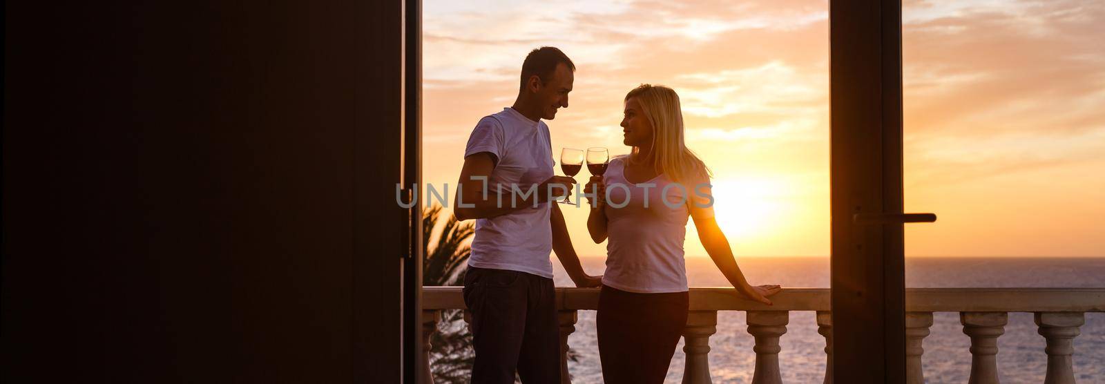 Couple on a cruise watching the sunset over the ocean