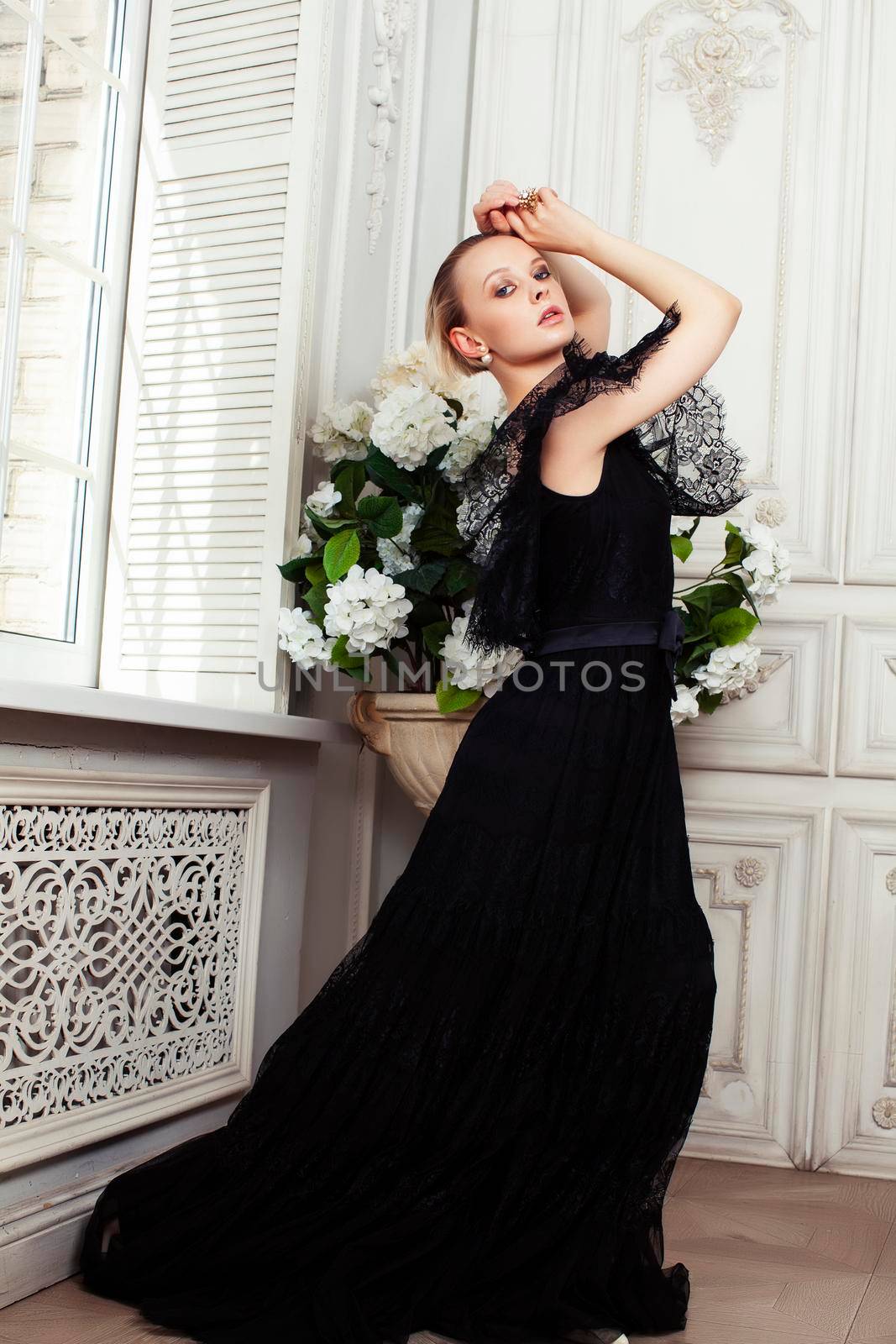 young pretty lady in black lace fashion style dress posing in rich interior of royal hotel room, luxury lifestyle people concept closeup
