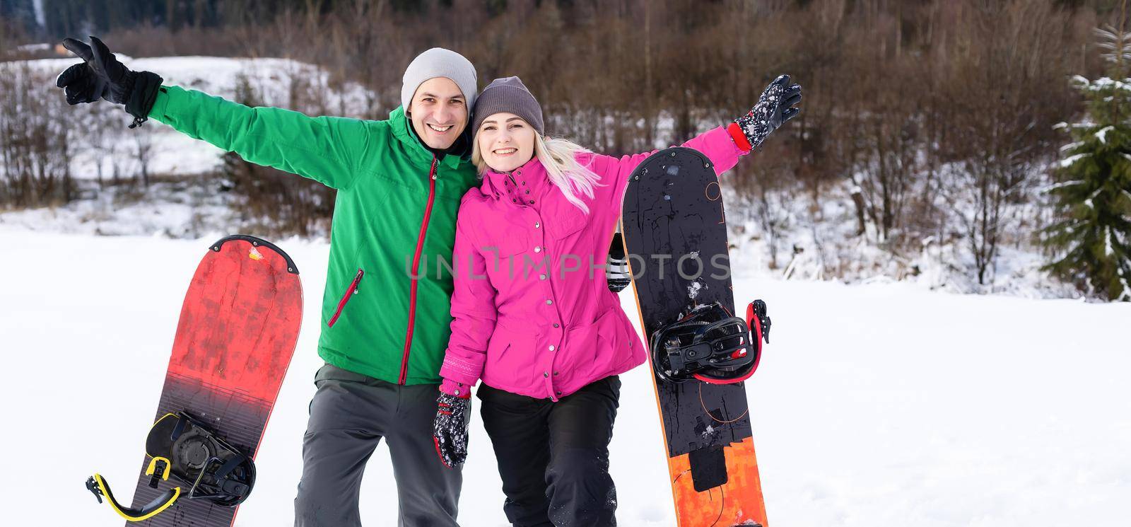 family with snowboards at winter resort by Andelov13