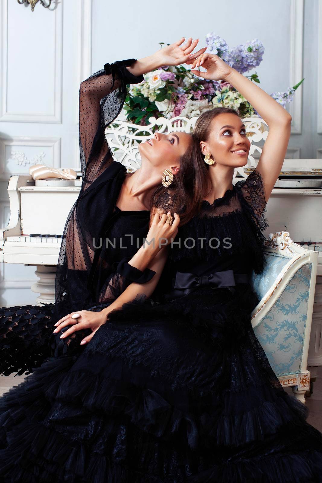 two young pretty lady in black lace fashion style dress posing in rich interior of royal hotel room, luxury lifestyle people concept closeup