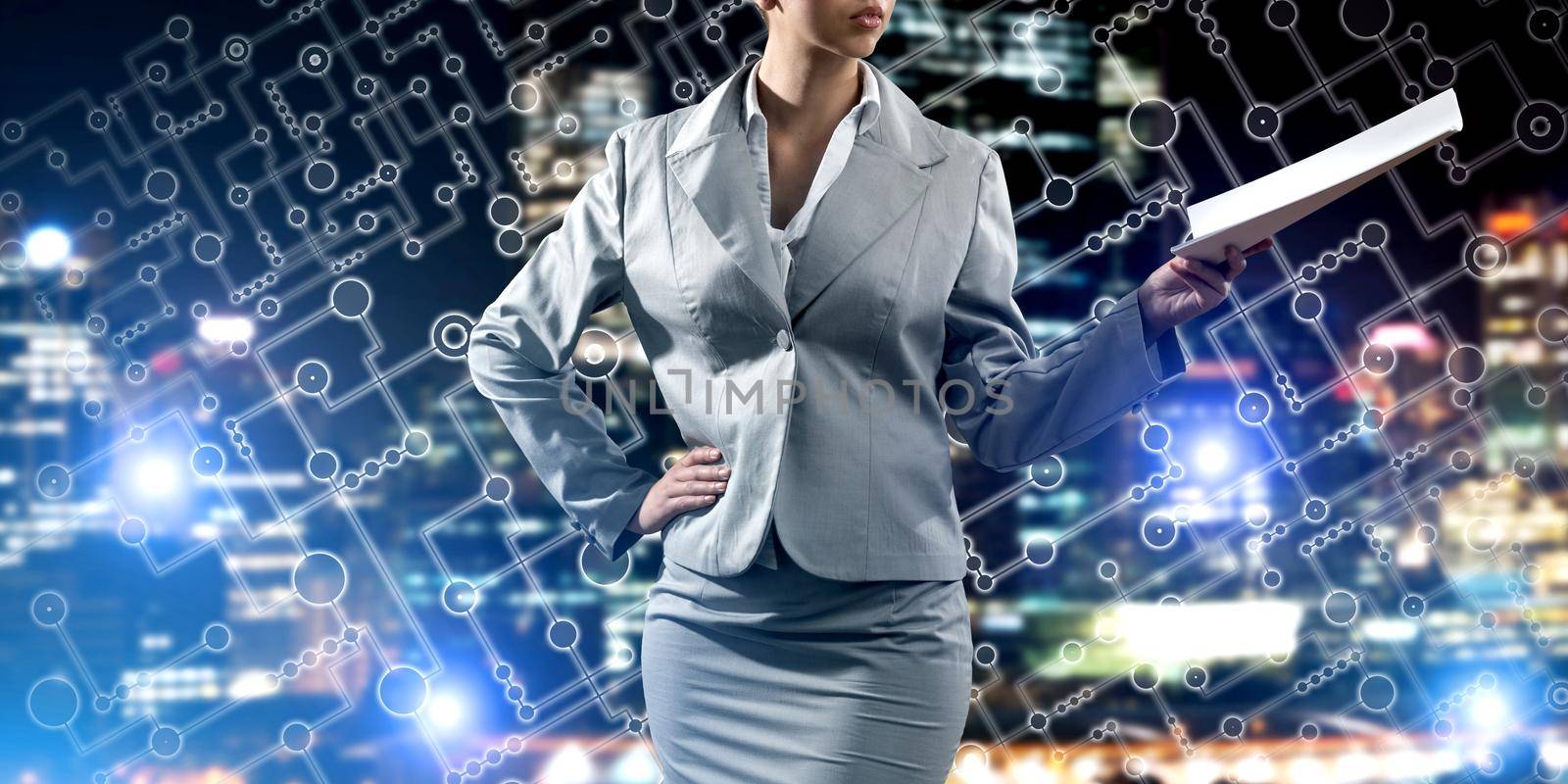 Close of businesswoman against night cityscape background and technology concept by adam121