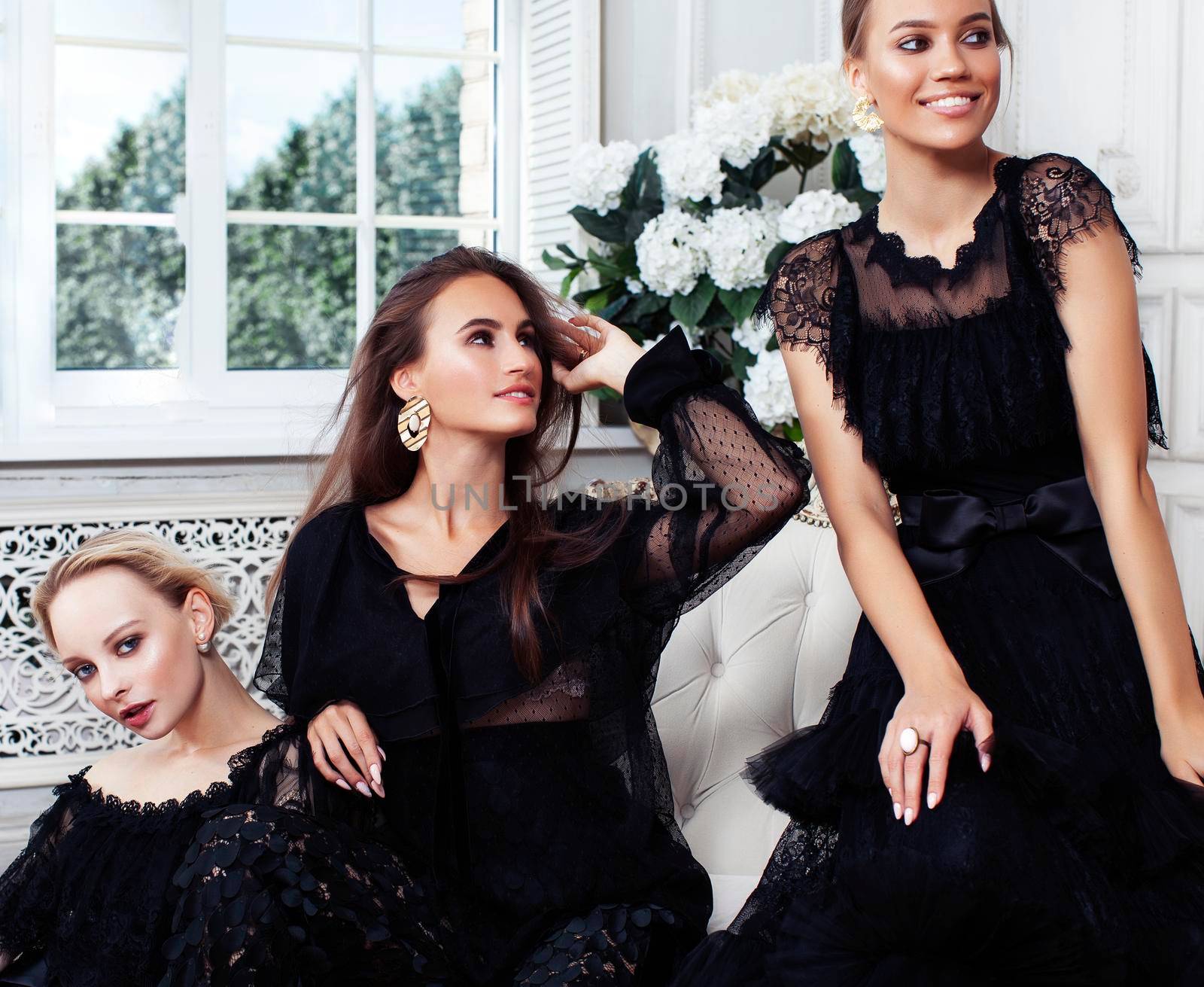 three young pretty lady in black lace fashion style dress posing in rich interior of royal hotel room, luxury lifestyle people concept closeup