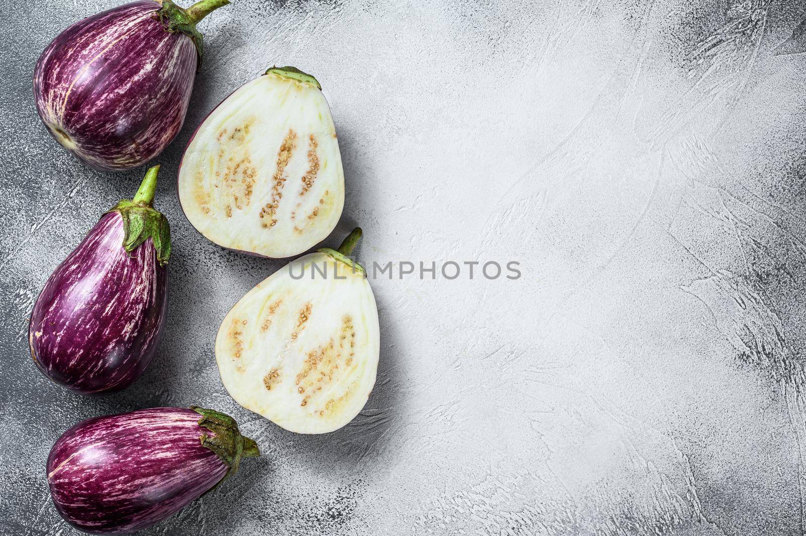 Raw purple Aubergine or eggplant. White background. Top view. Copy space by Composter