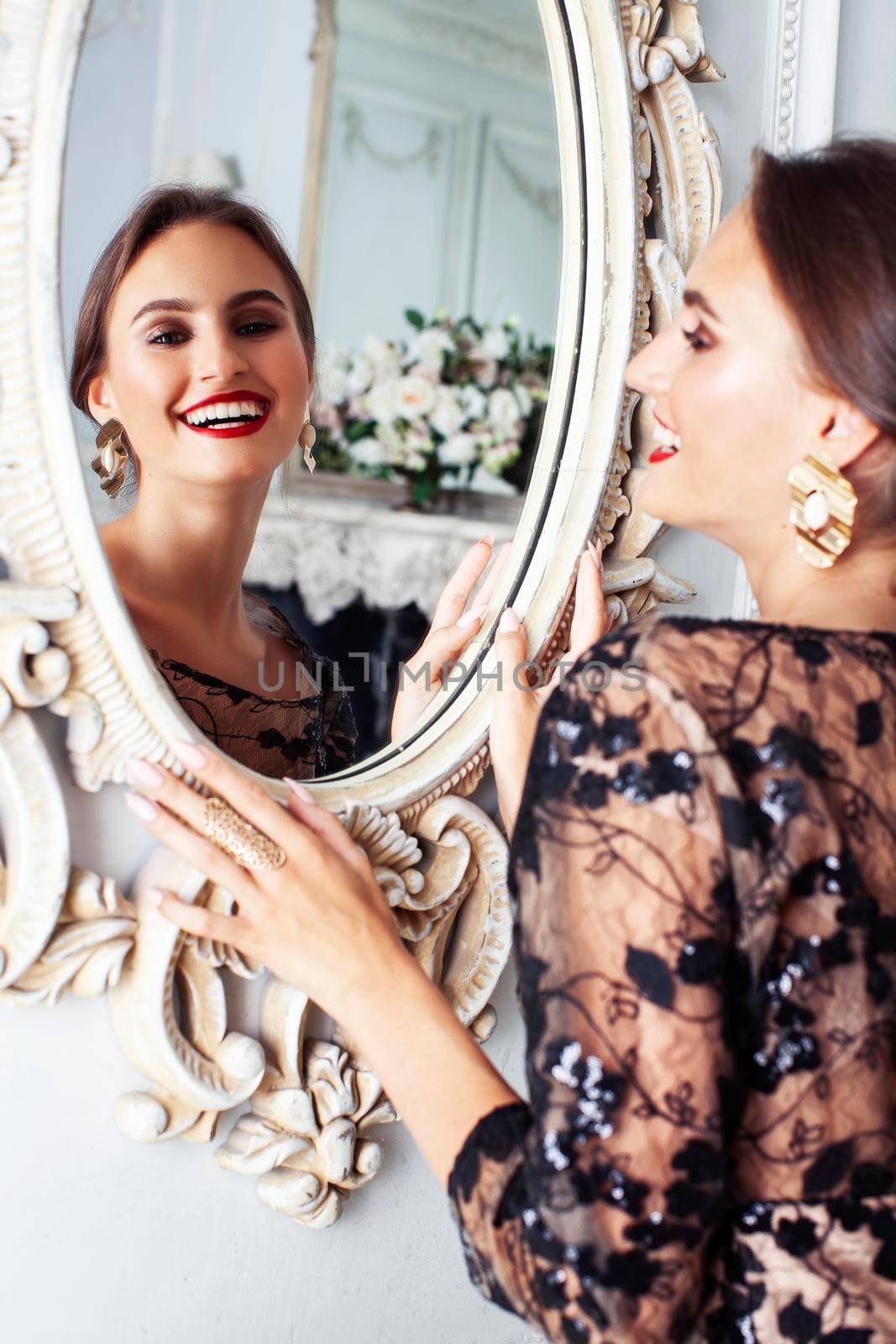 young pretty woman in black lace fashion style dress posing in rich interior of royal hotel room, luxury lifestyle people concept closeup