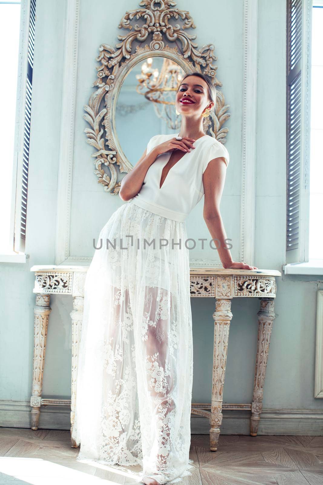 young pretty lady in white lace fashion style dress posing in rich interior of royal hotel room, luxury lifestyle people concept, bride on wedding day closeup