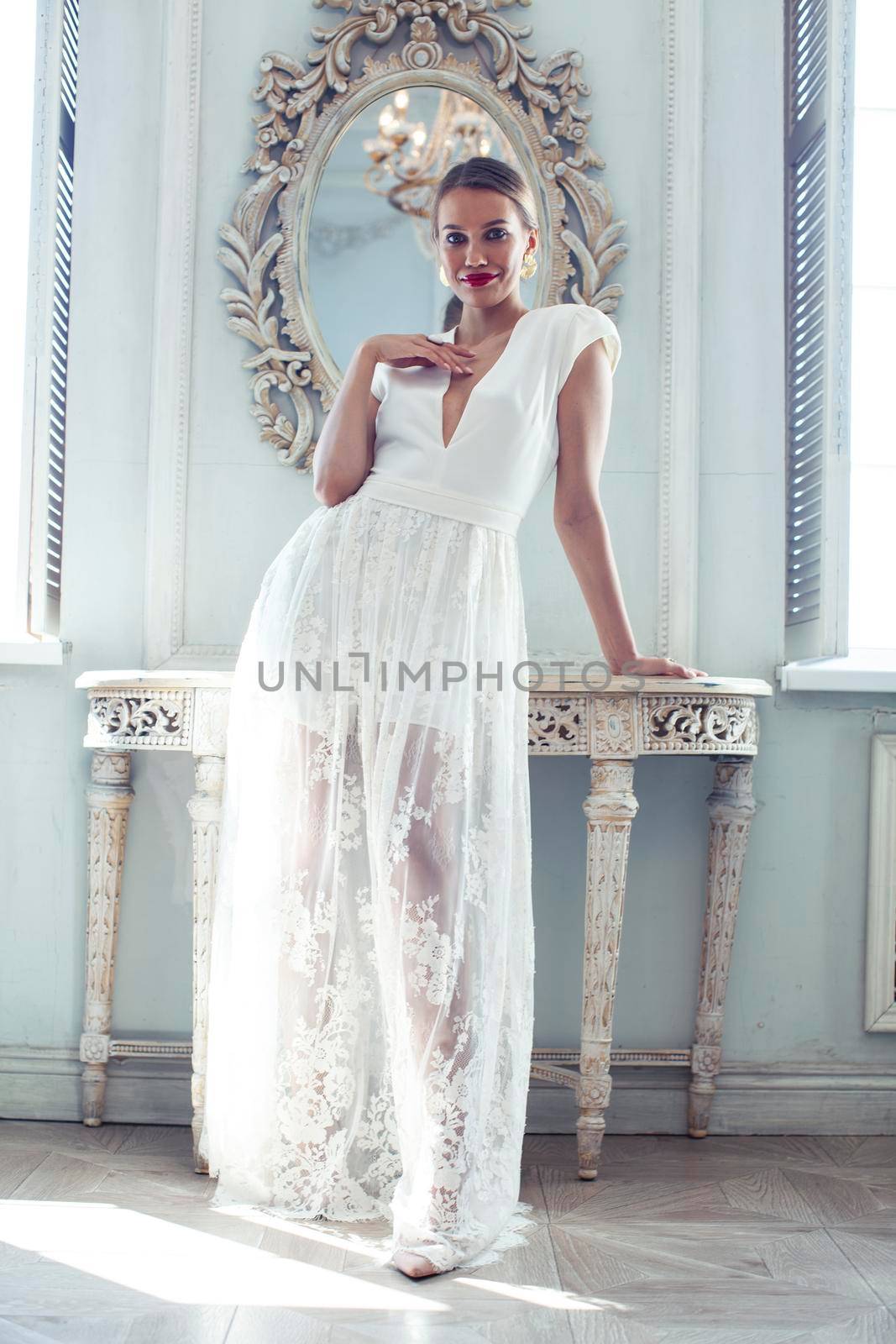 young pretty lady in white lace fashion style dress posing in rich interior of royal hotel room, luxury lifestyle people concept, bride on wedding day closeup