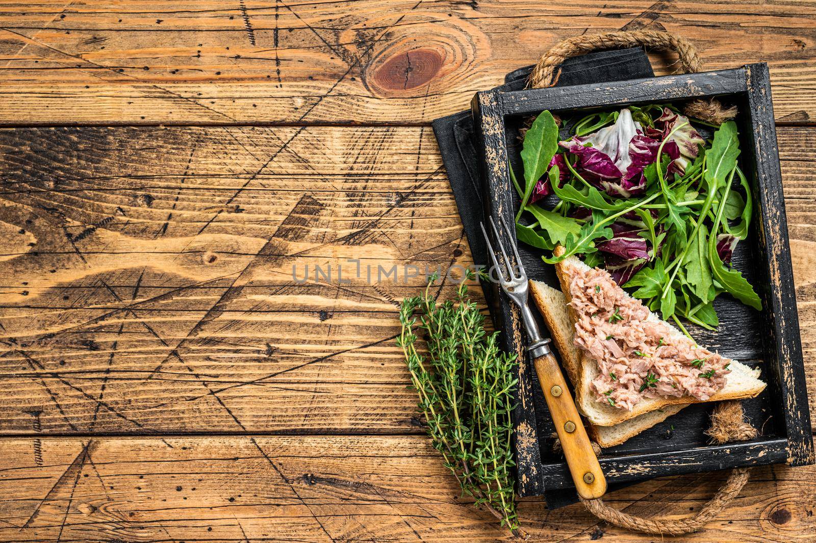 Tuna Salad Sandwich with Cheese, lettuce and arugula. Wooden background. Top view. Copy space.