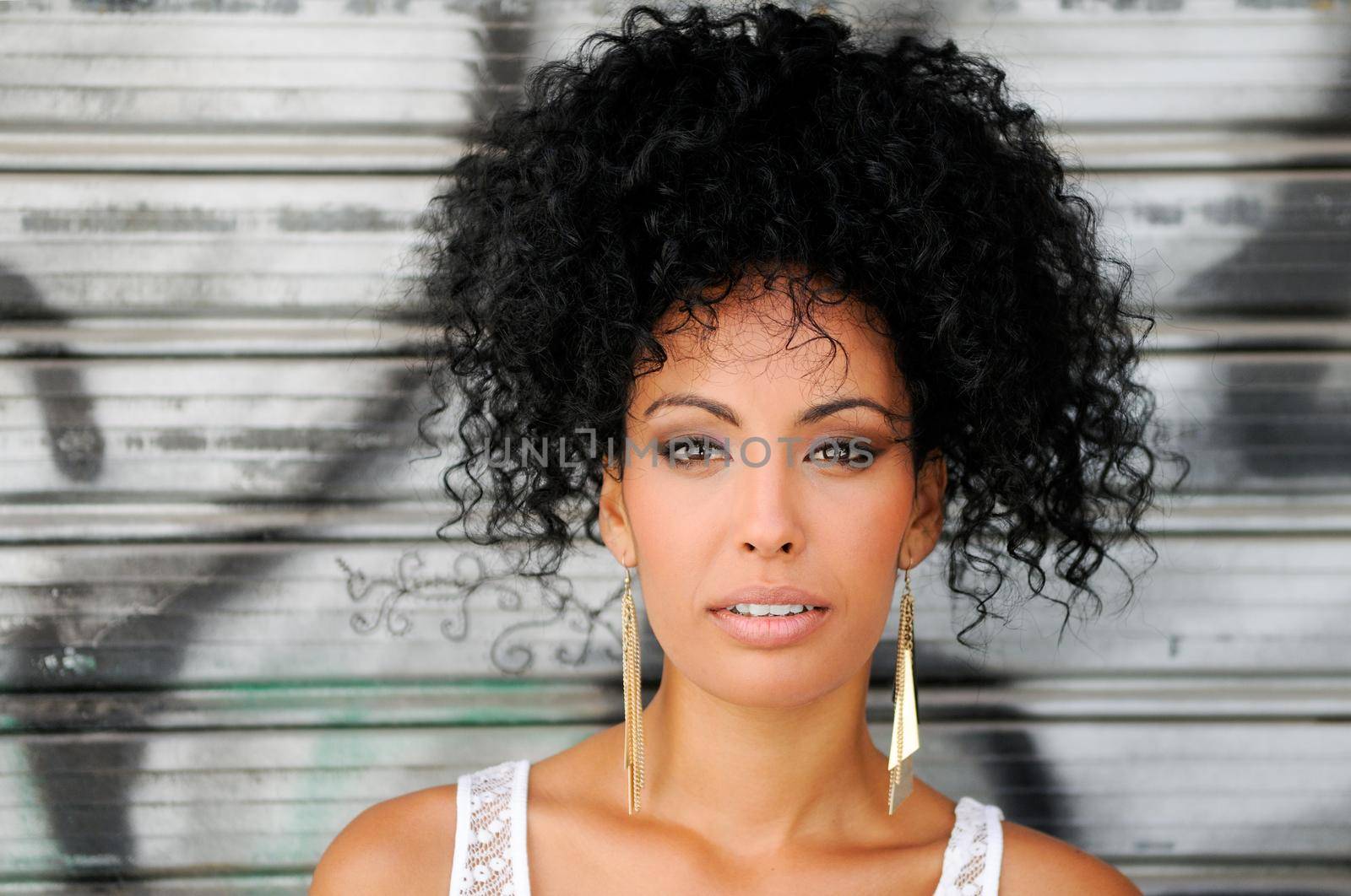 Portrait of a young black woman, model of fashion in urban background