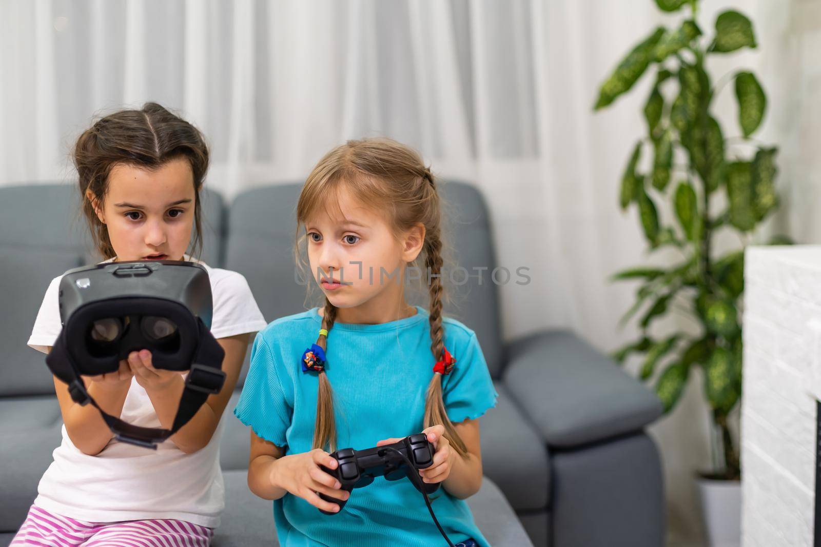Young girls with virtual reality glasses. VR headset. by Andelov13