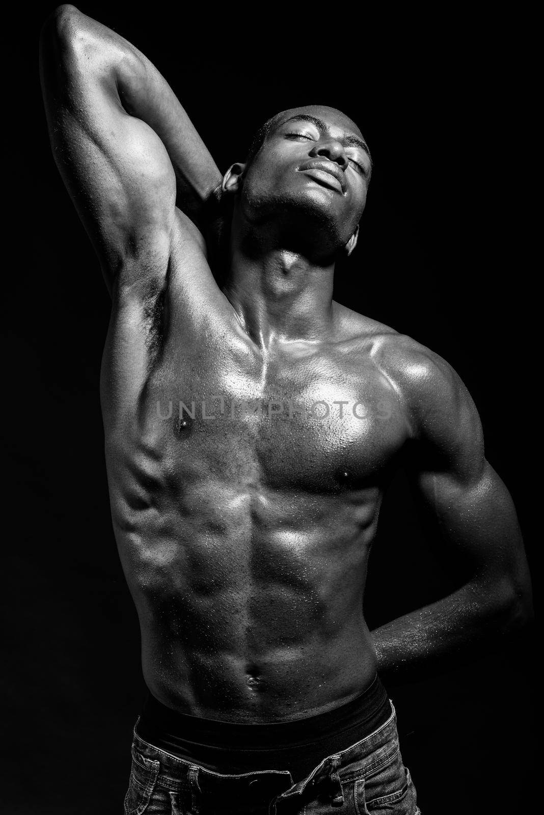 Athletic black man on black background by javiindy