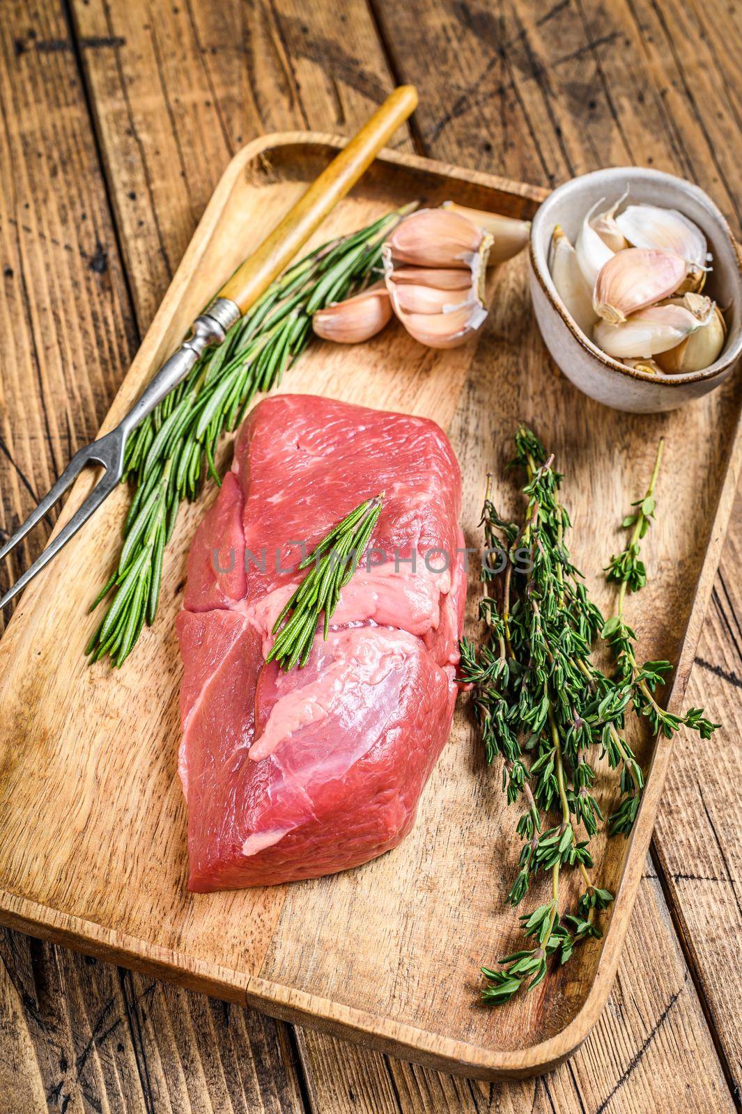Raw fresh veal fillet meat steak with herbs. wooden background. Top view by Composter