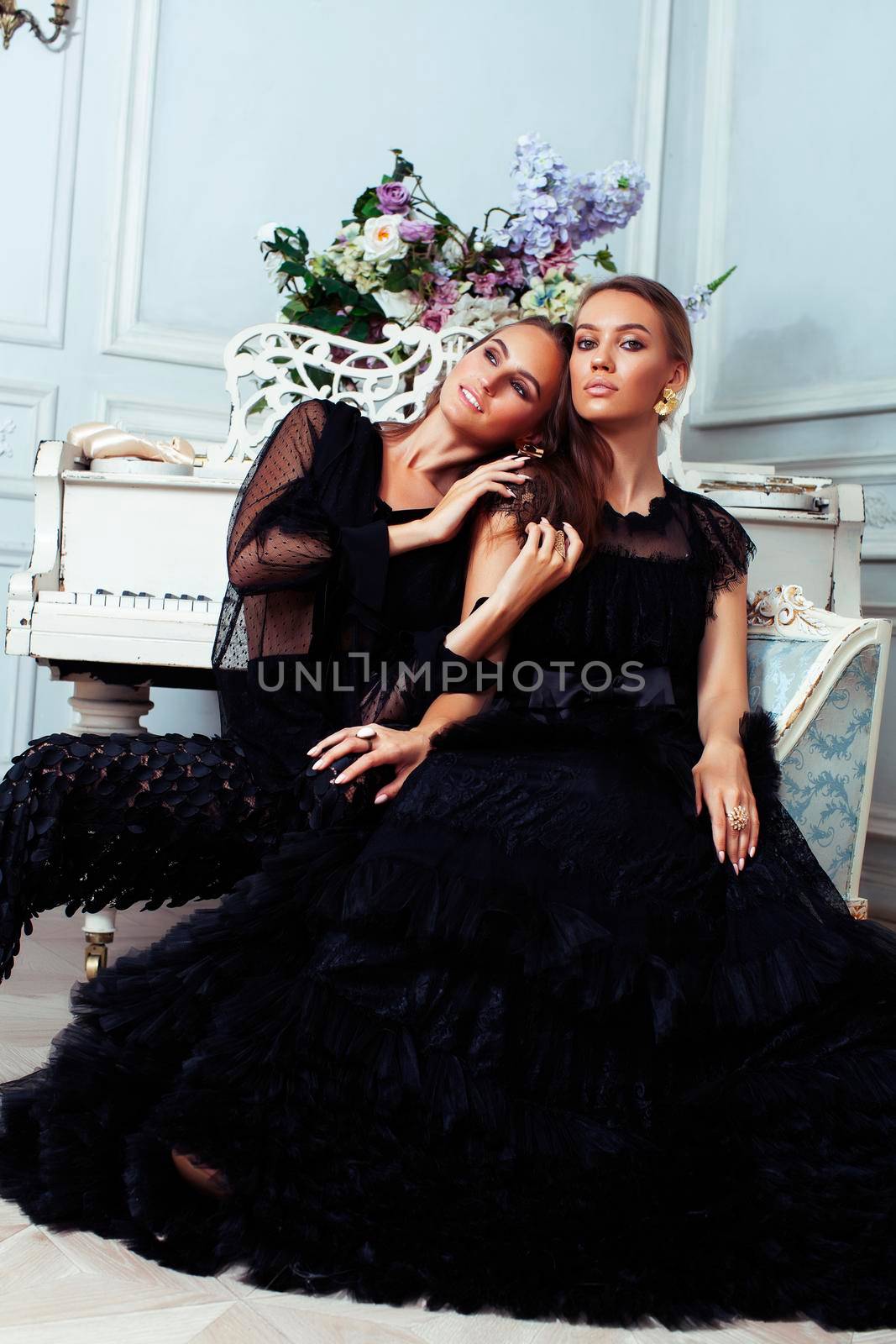 two young pretty lady in black lace fashion style dress posing in rich interior of royal hotel room, luxury lifestyle people concept by JordanJ