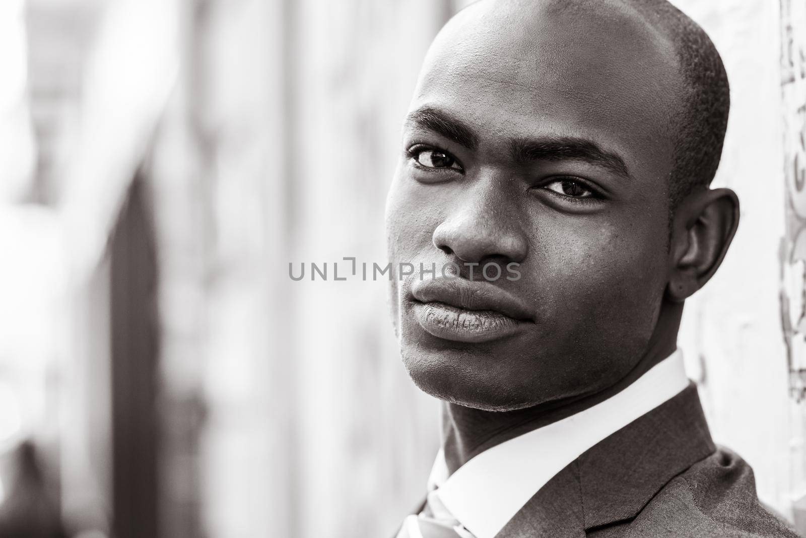 Portrait of handsome black man wearing suit in urban background