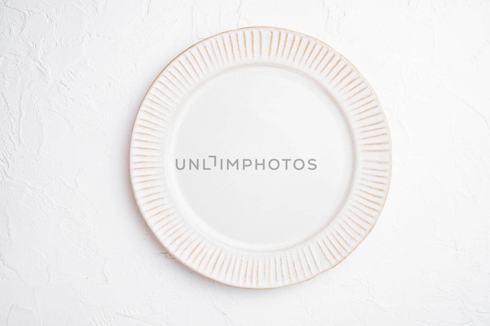 White plate empty utensil set with copy space for text or food with copy space for text or food, top view flat lay, on white stone table background
