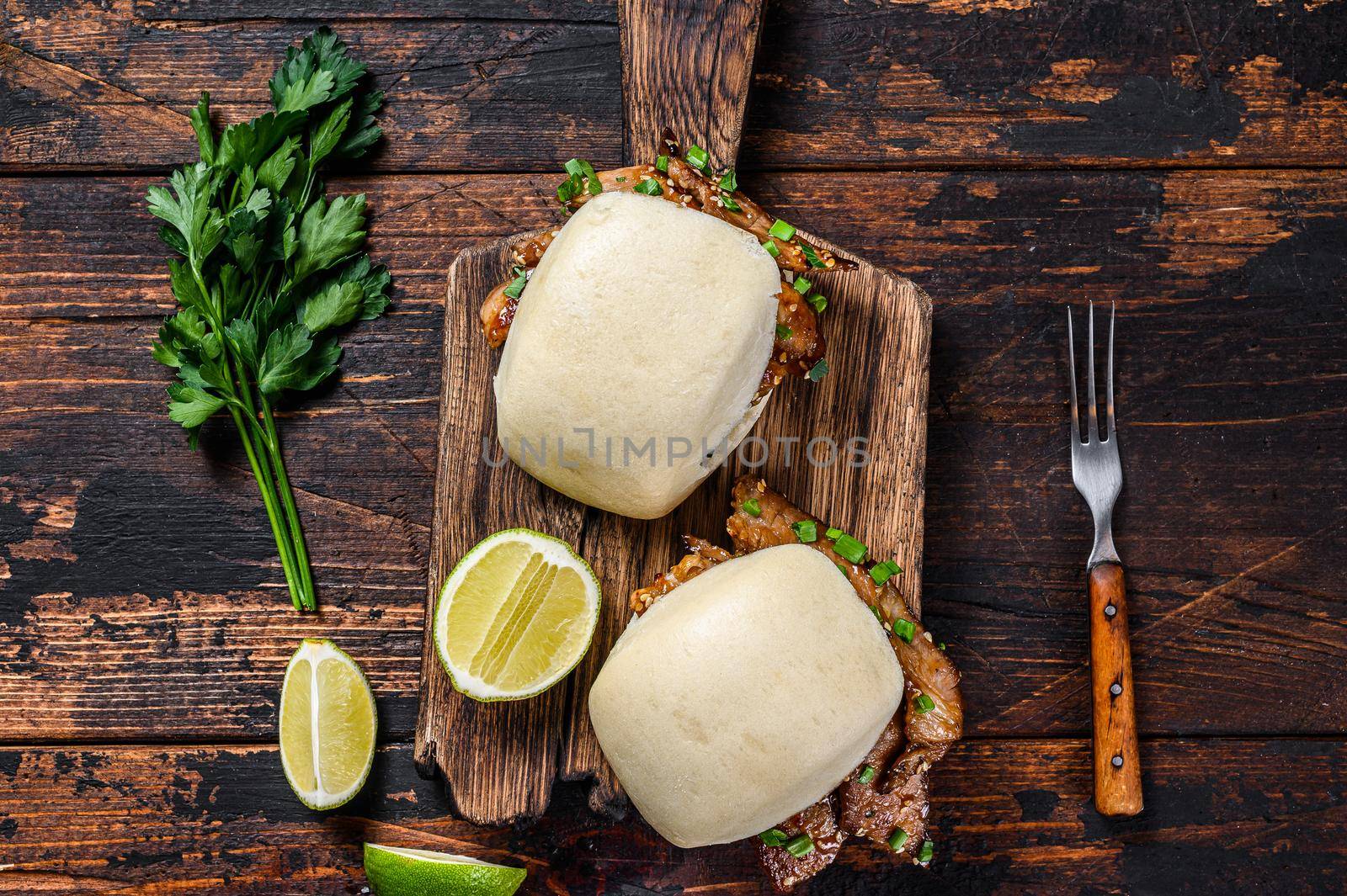 Chinese sandwich steamed gua bao buns with pork. Black background. Top view.