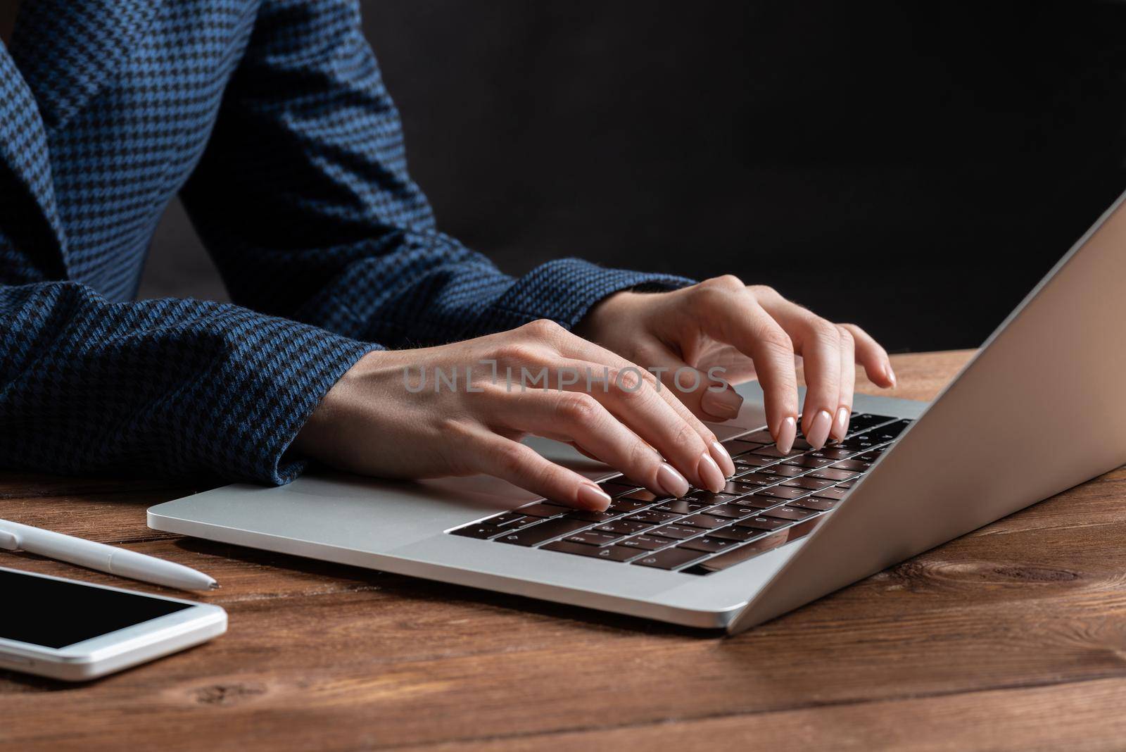 Business lady typing on laptop computer at wooden desk. Strategy planning and banking. Financial analyst working in office. Business accounting and project management. Close up woman hands on keyboard