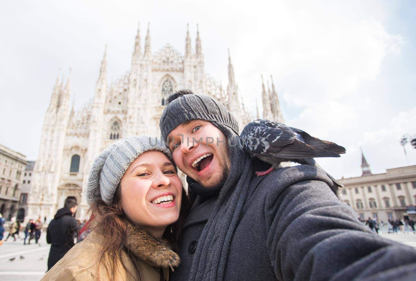 Couple taking self portrait in Duomo square. Concept about traveling and relationship