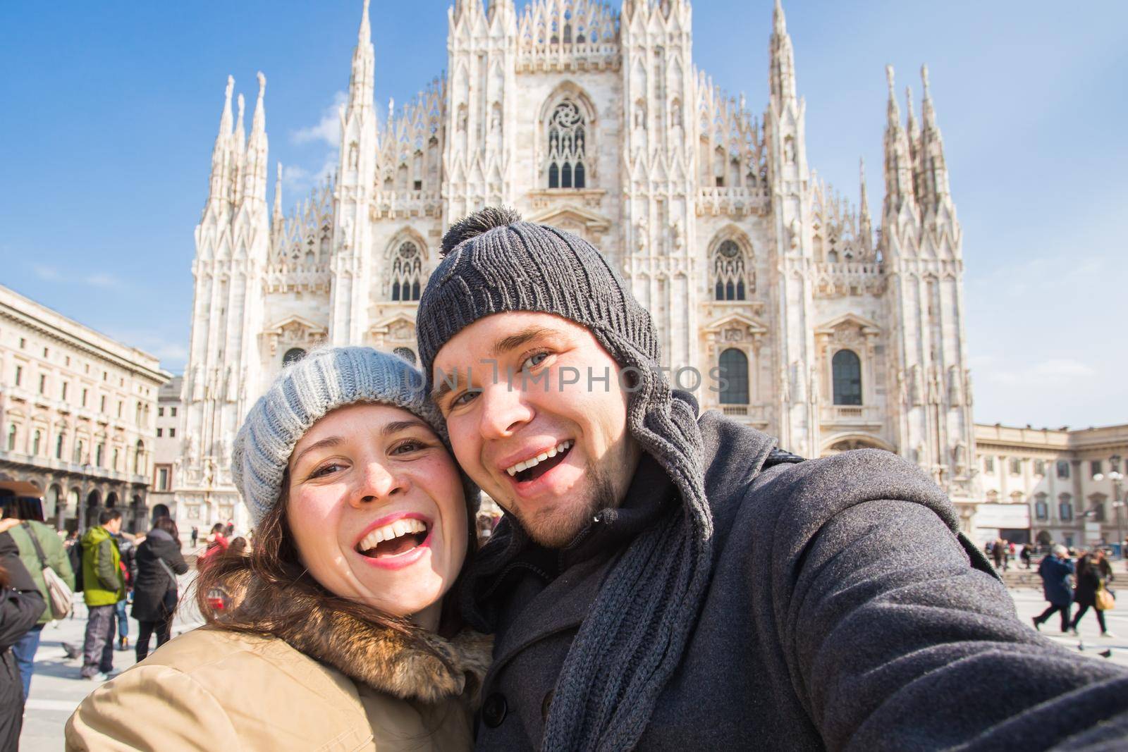 Travel, photographing and people concept - Happy couple taking self portrait in Duomo square.