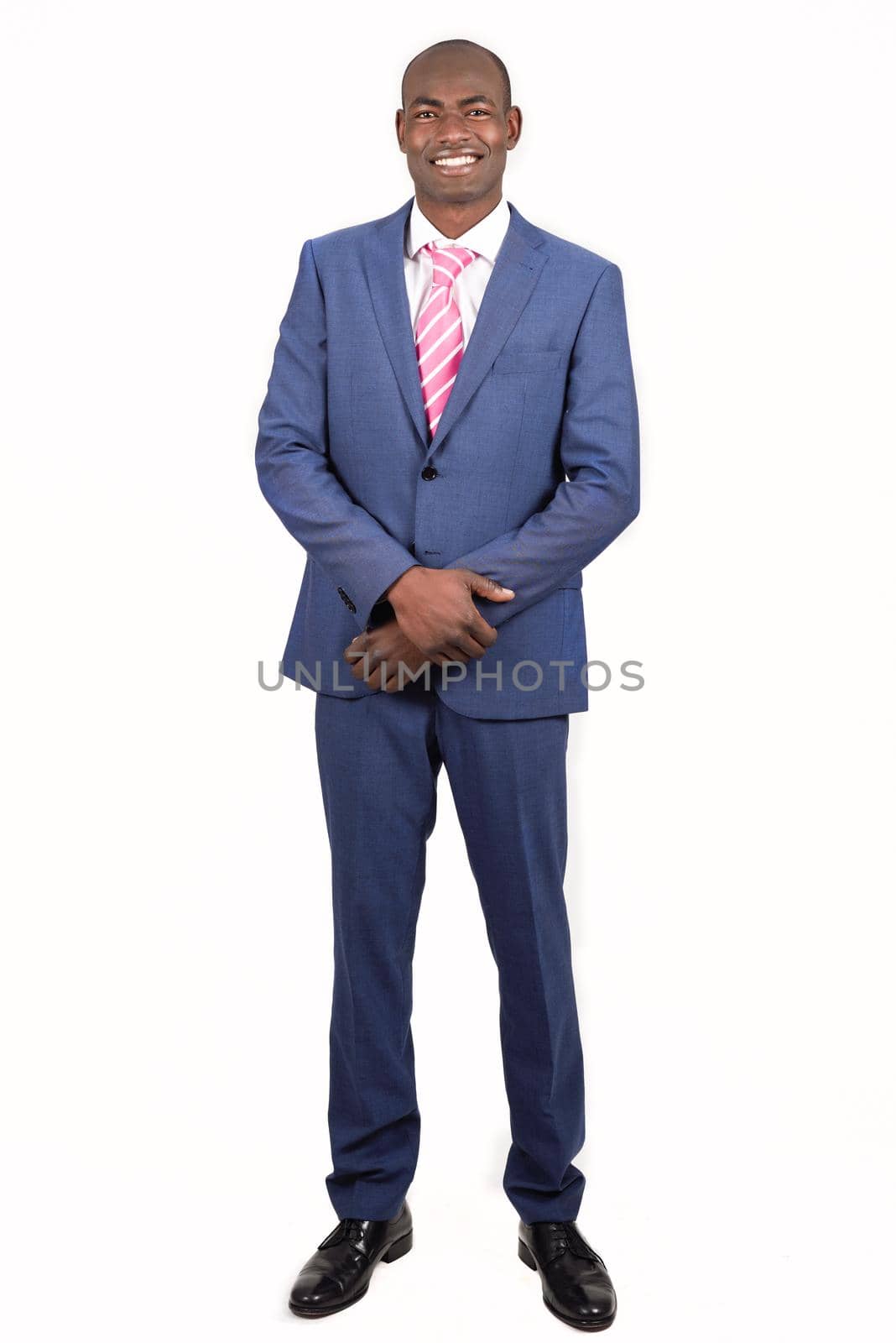Portrait of black businessman wearing suit and tie smiling on white background. Studio shot