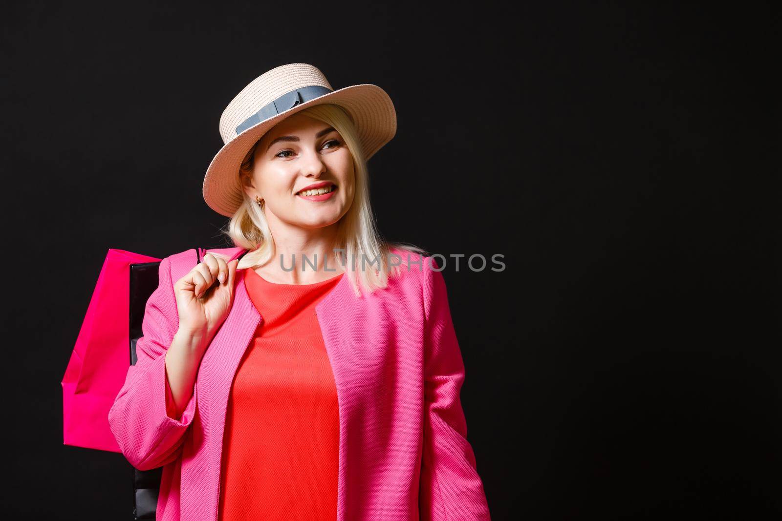 Shopping woman holding bags, isolated on black background. black friday concept