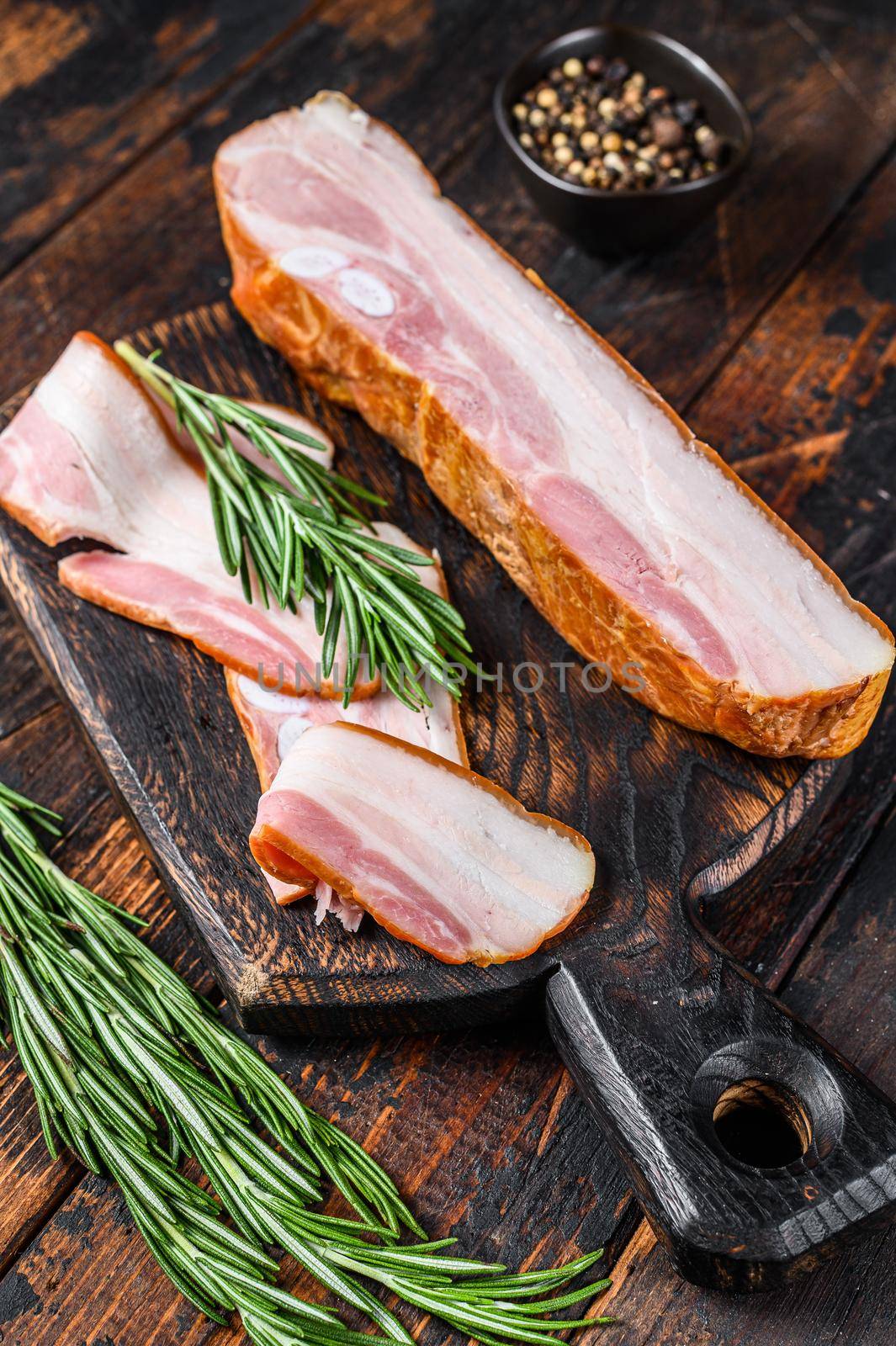 Raw pork belly with skin. Dark wooden background. Top view.