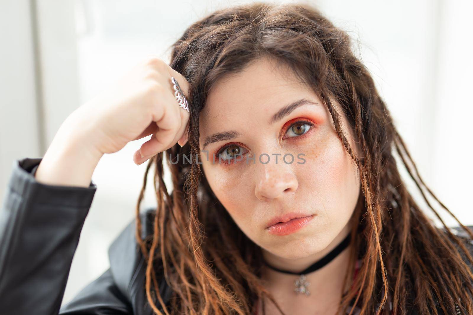Dreadlocks, hairdresser and style concept - A stylish girl with dreadlocks and in leather jacket and fashionable makeup by Satura86