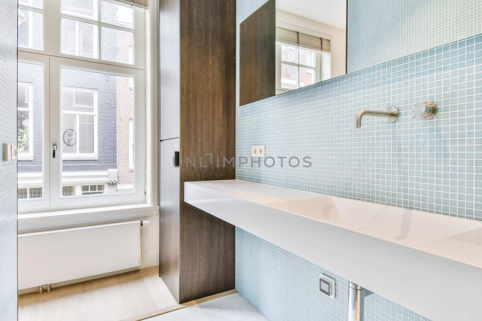 Bathroom with a long sink and mirror