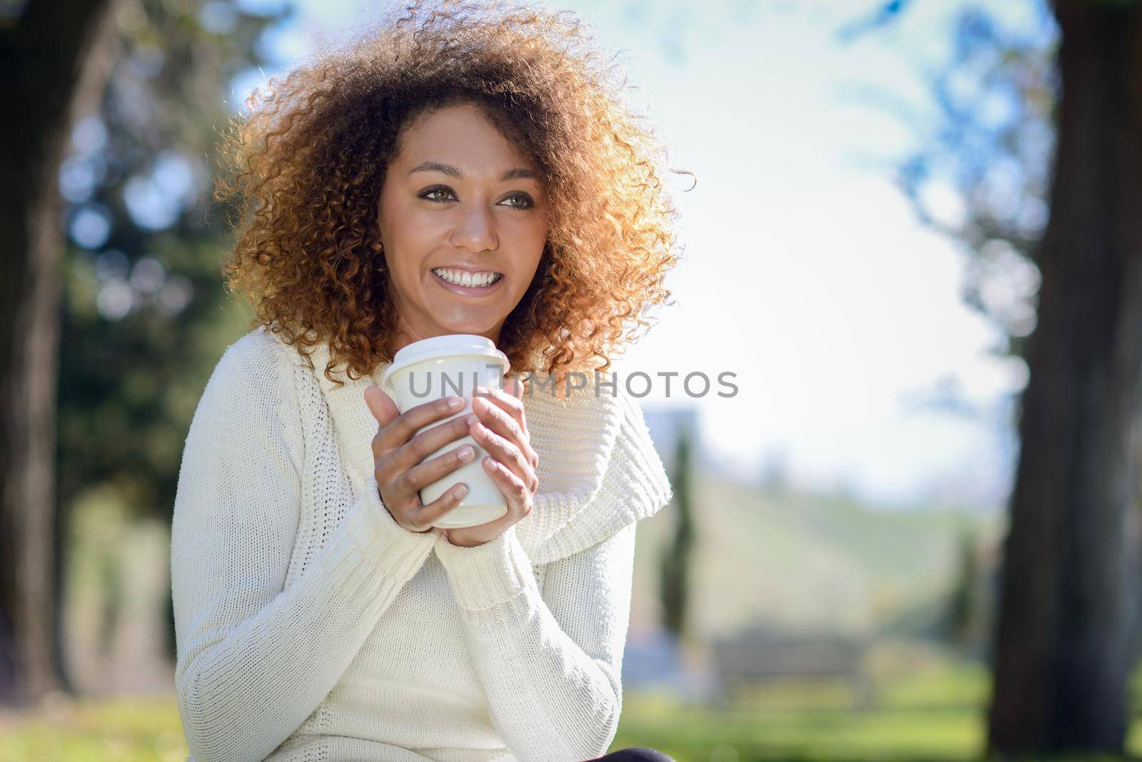 Young African American girl with afro hairstyle with coffee cup by javiindy