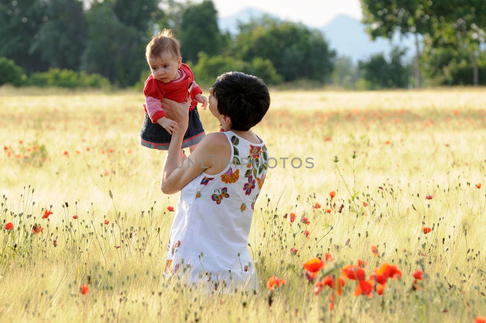 Mother and daughter in a poppy field by javiindy