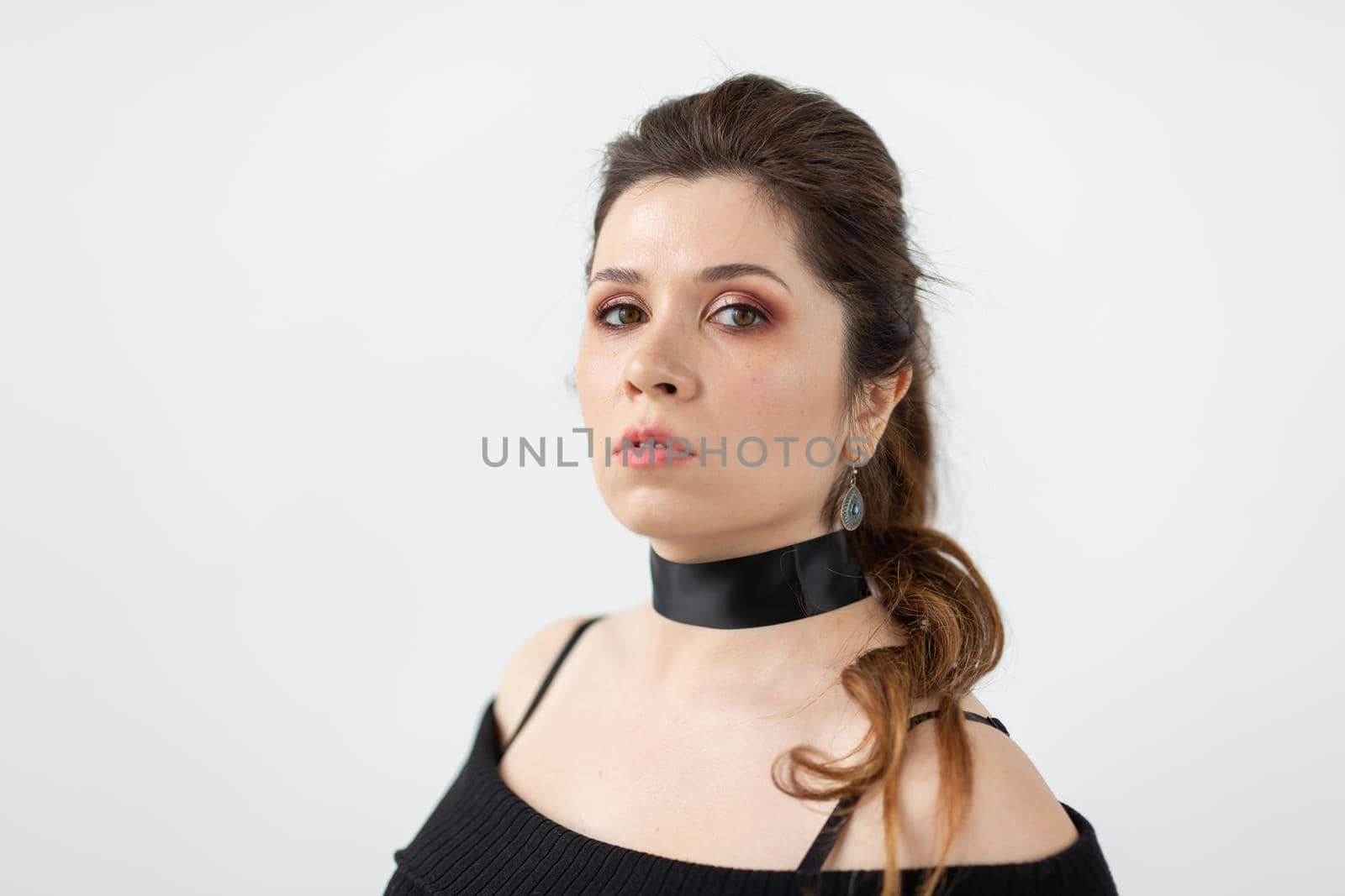 Portrait of a beautiful romantic young woman with black ribbon on the neck posing on a white background. Beauty concept by Satura86