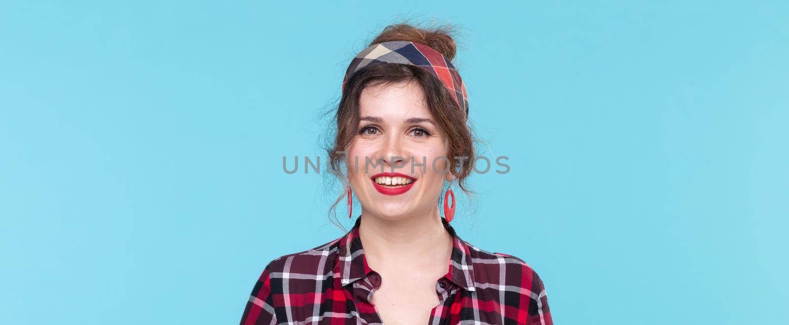 retro, vintage, people concept - woman in retro style smilling over the blue background.