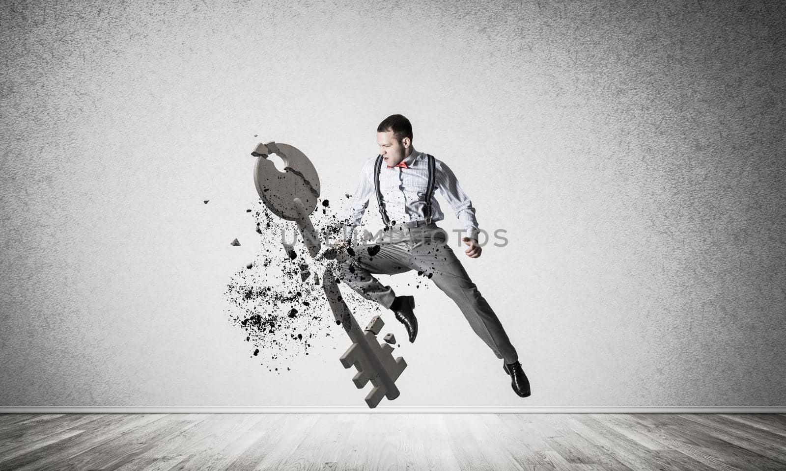 Determined businessman jumping and breaking with kick stone key figure