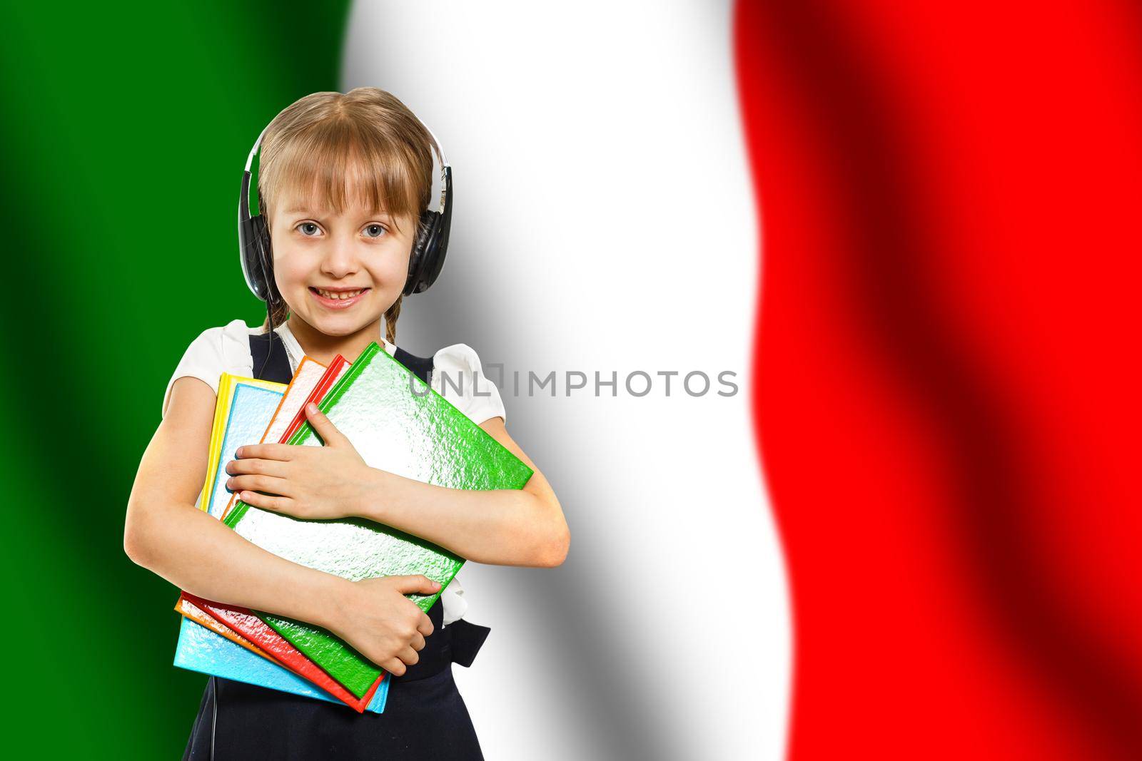 Happy young girl holding books, on the background of the flag of Italy. The concept of language learning and study. Travels.