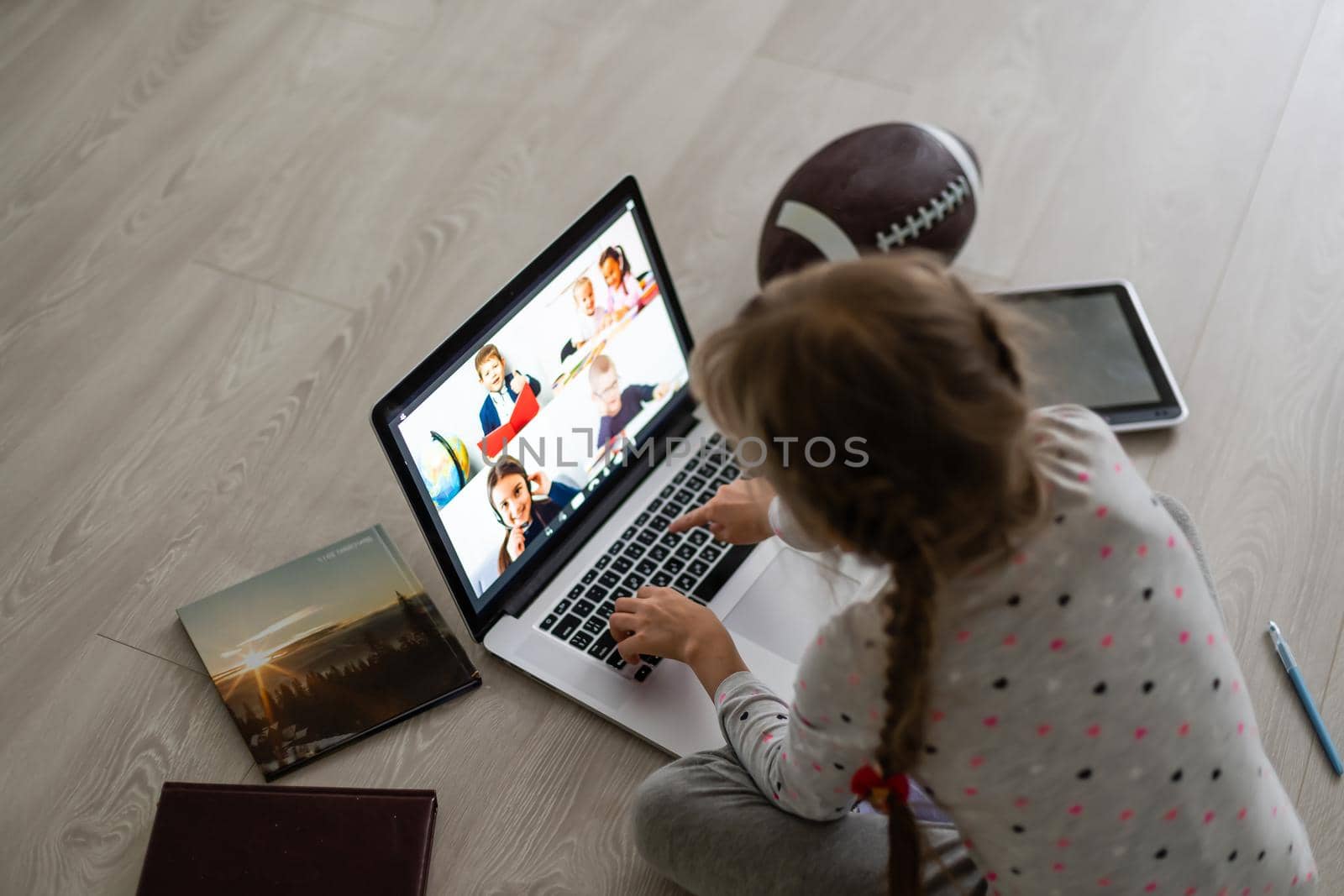 Little girl using video chat on laptop at home. Space for text by Andelov13