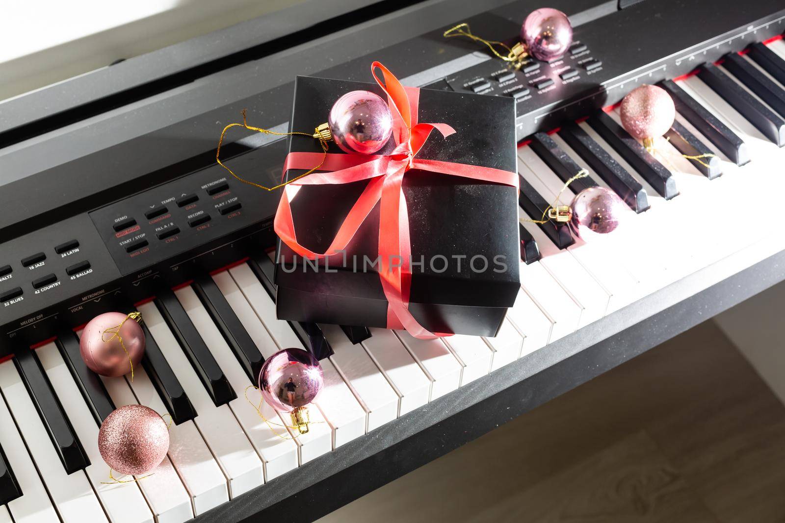 Christmas gift box on a piano keyboard, above view