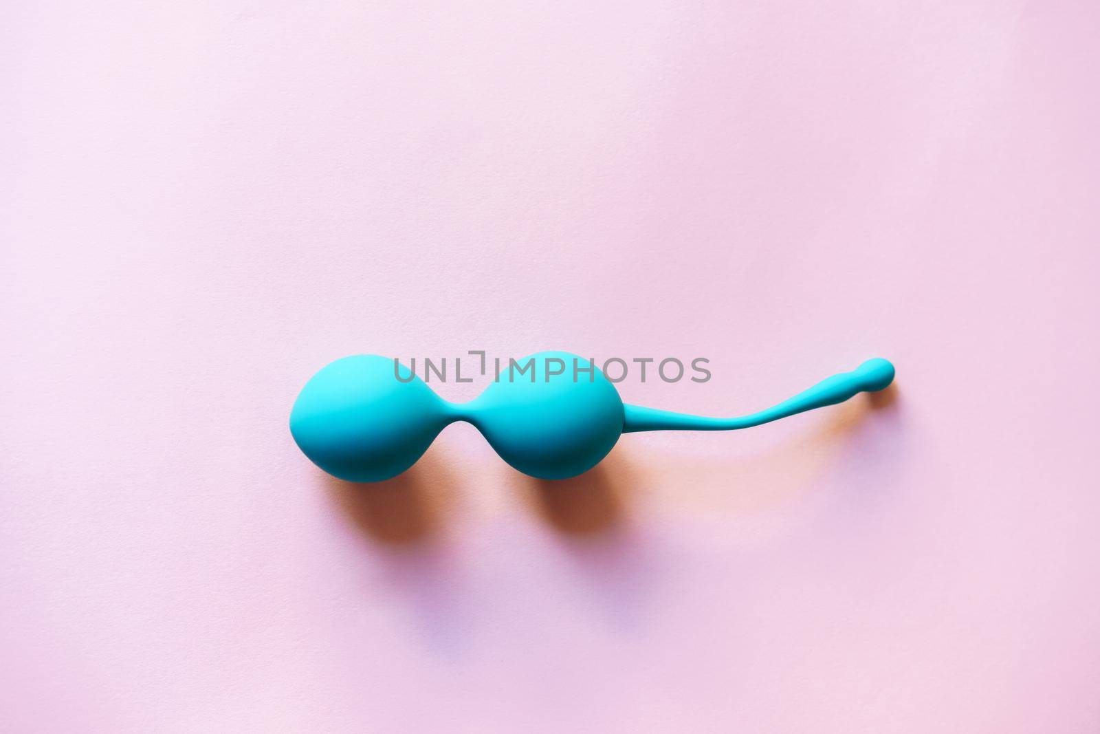 Set of two Blue Kegel balls, Geisha balls in pink background.