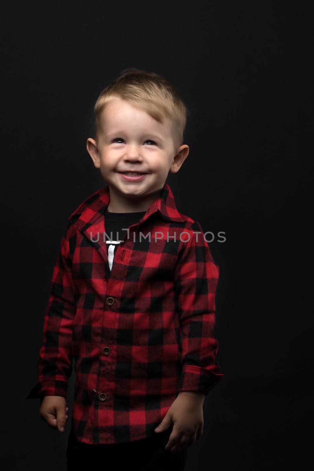 Little boy on a black background. by kolesnikov_studio