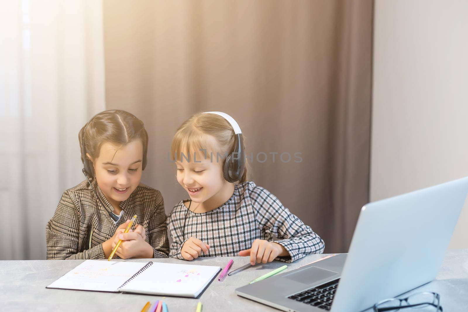 Two little girls doing their school homework by Andelov13