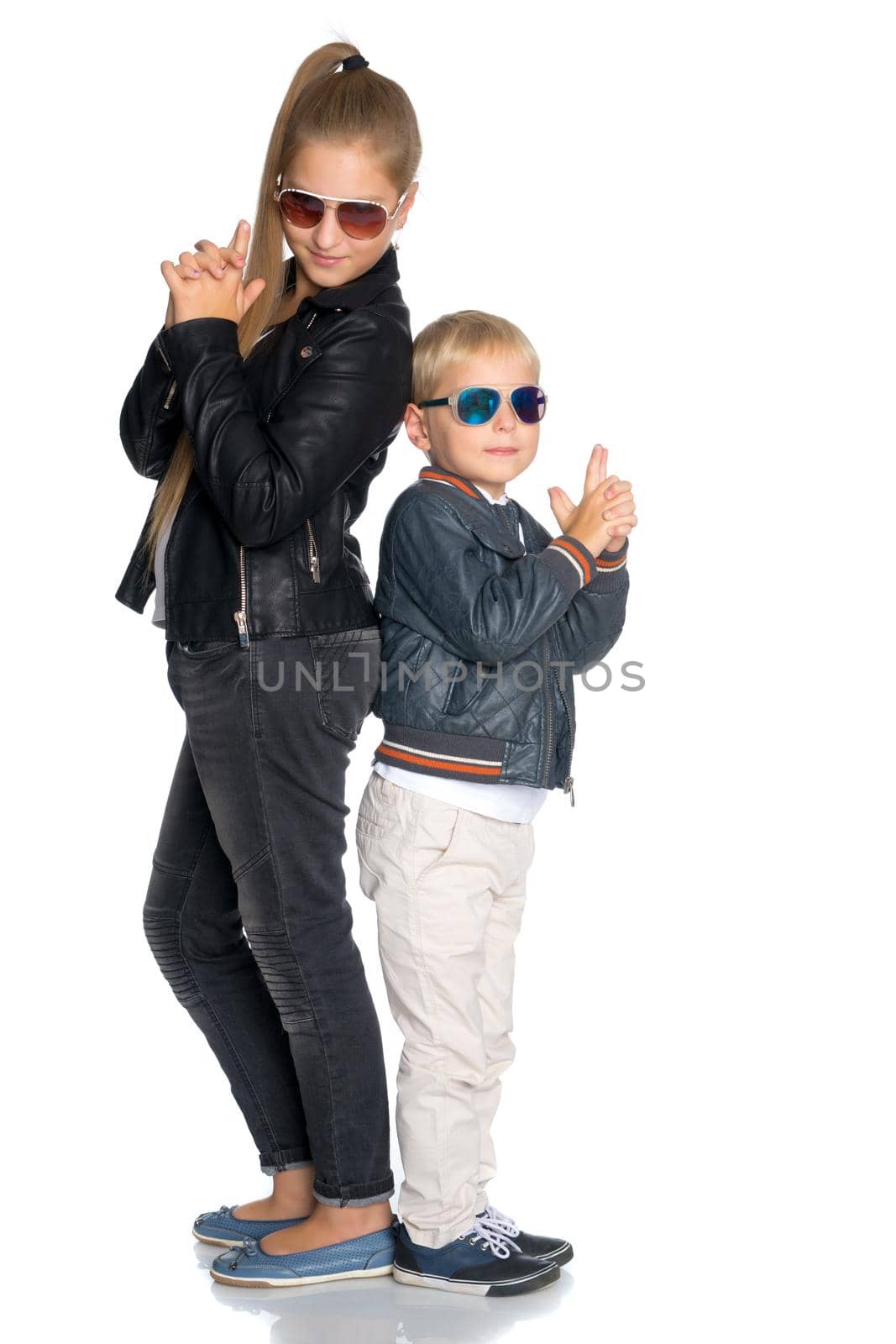 A teenage girl with her younger brother. studio photo session. The concept of family happiness.Isolated on white background.