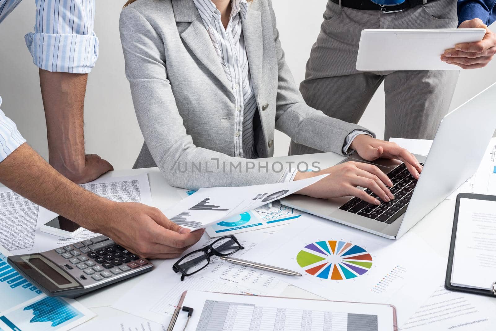 Corporate teamwork concept with businessmen. Secretary working with laptop Office desk with financial charts. Secretary working with laptop computer. Presentation and discussion of new startup project