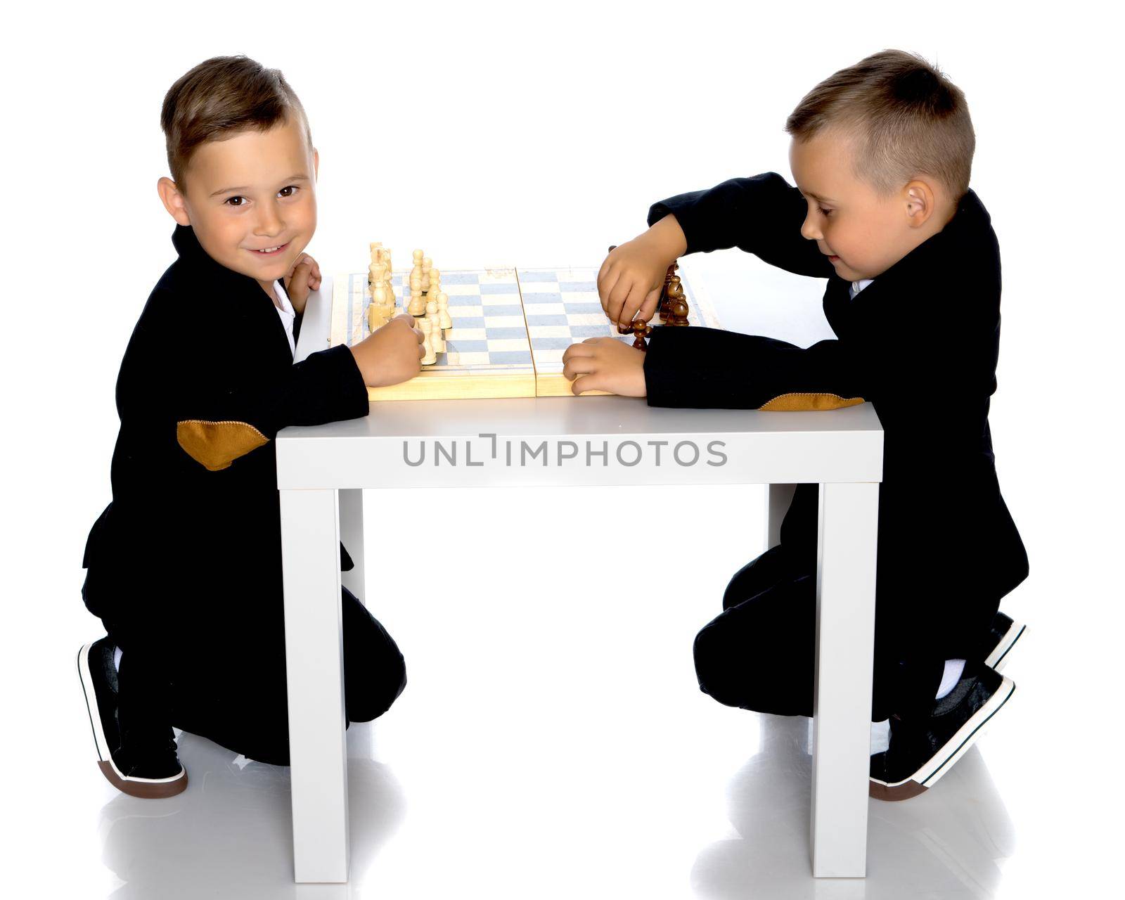Two brothers are playing chess at home. Game, education, lifestyle concept.Isolated on white background