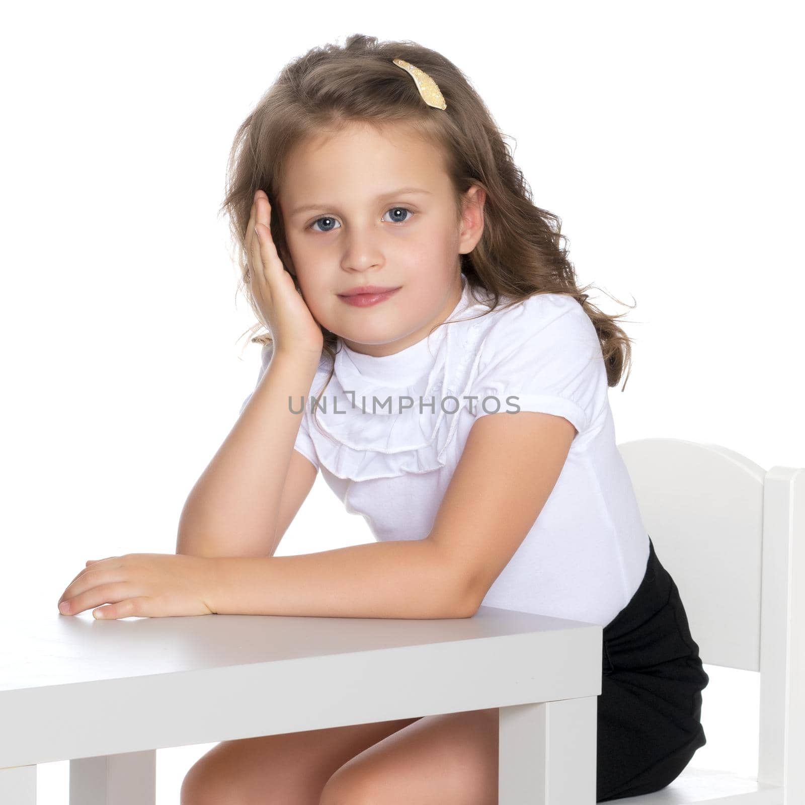 Little girl is sitting at the table by kolesnikov_studio
