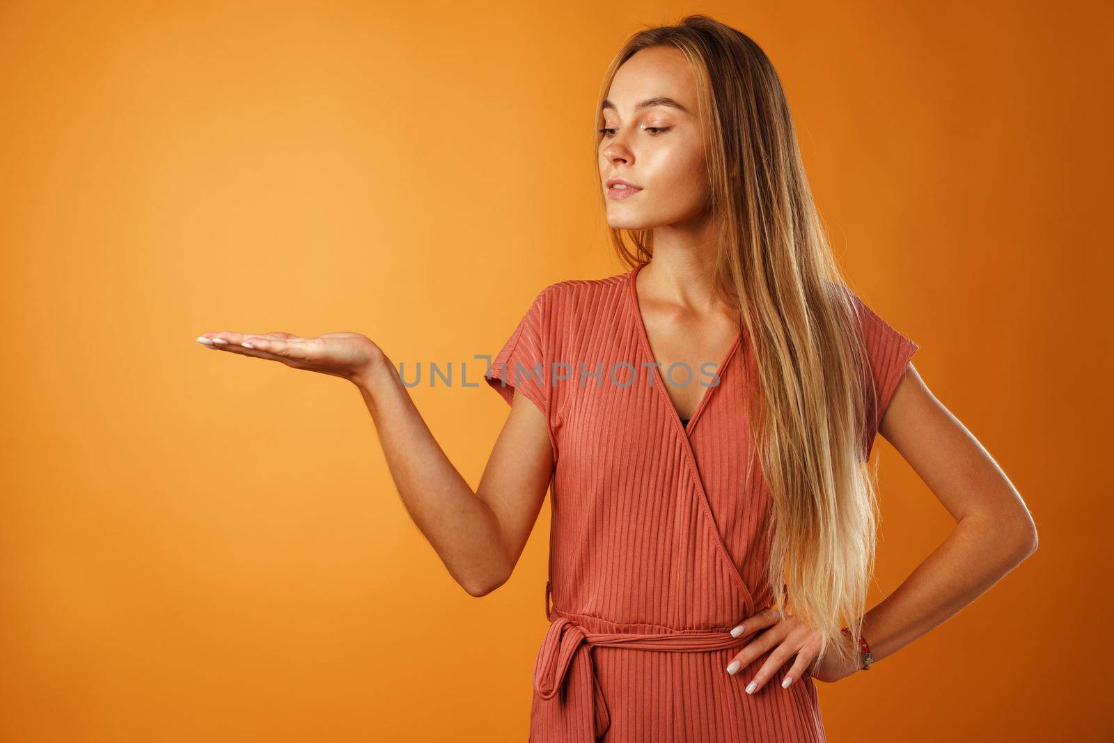 Portrait charming pretty cheerful girl showing copy space close up