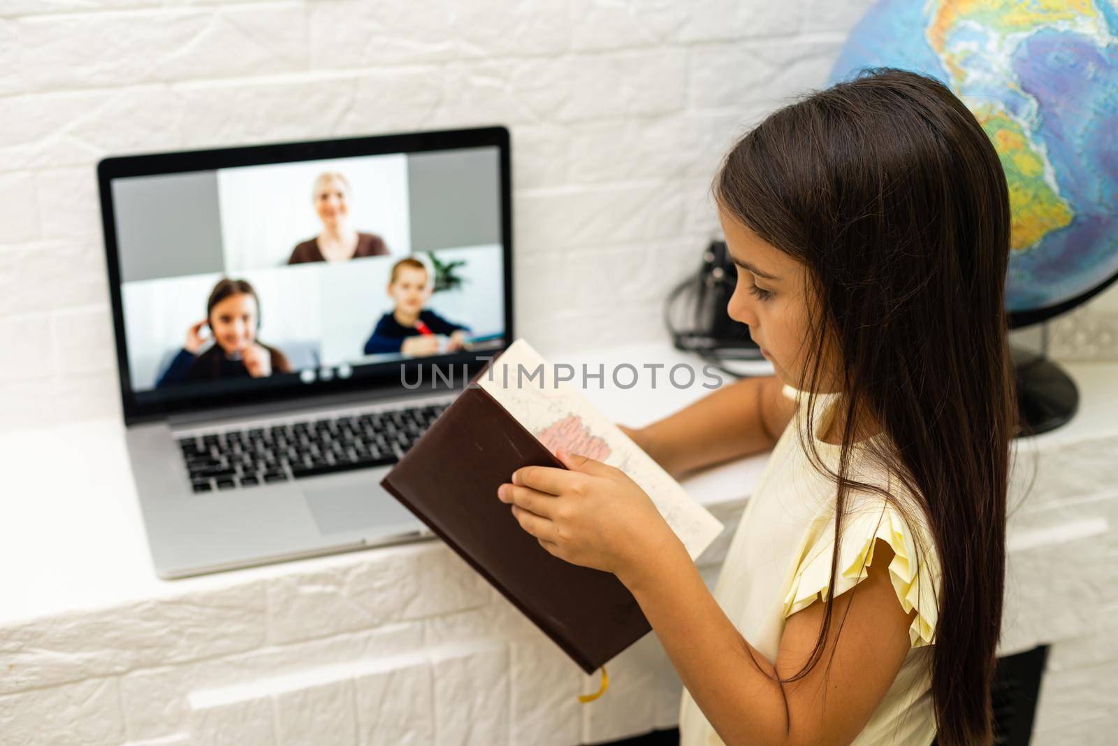 cheerful young little girl children using laptop computer, studying through online e-learning system