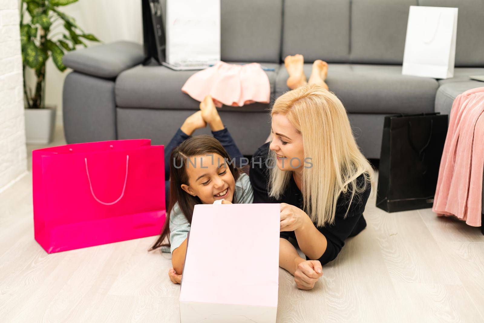 holidays, presents, christmas, x-mas, birthday concept - happy mother and child girl with gift bags by Andelov13