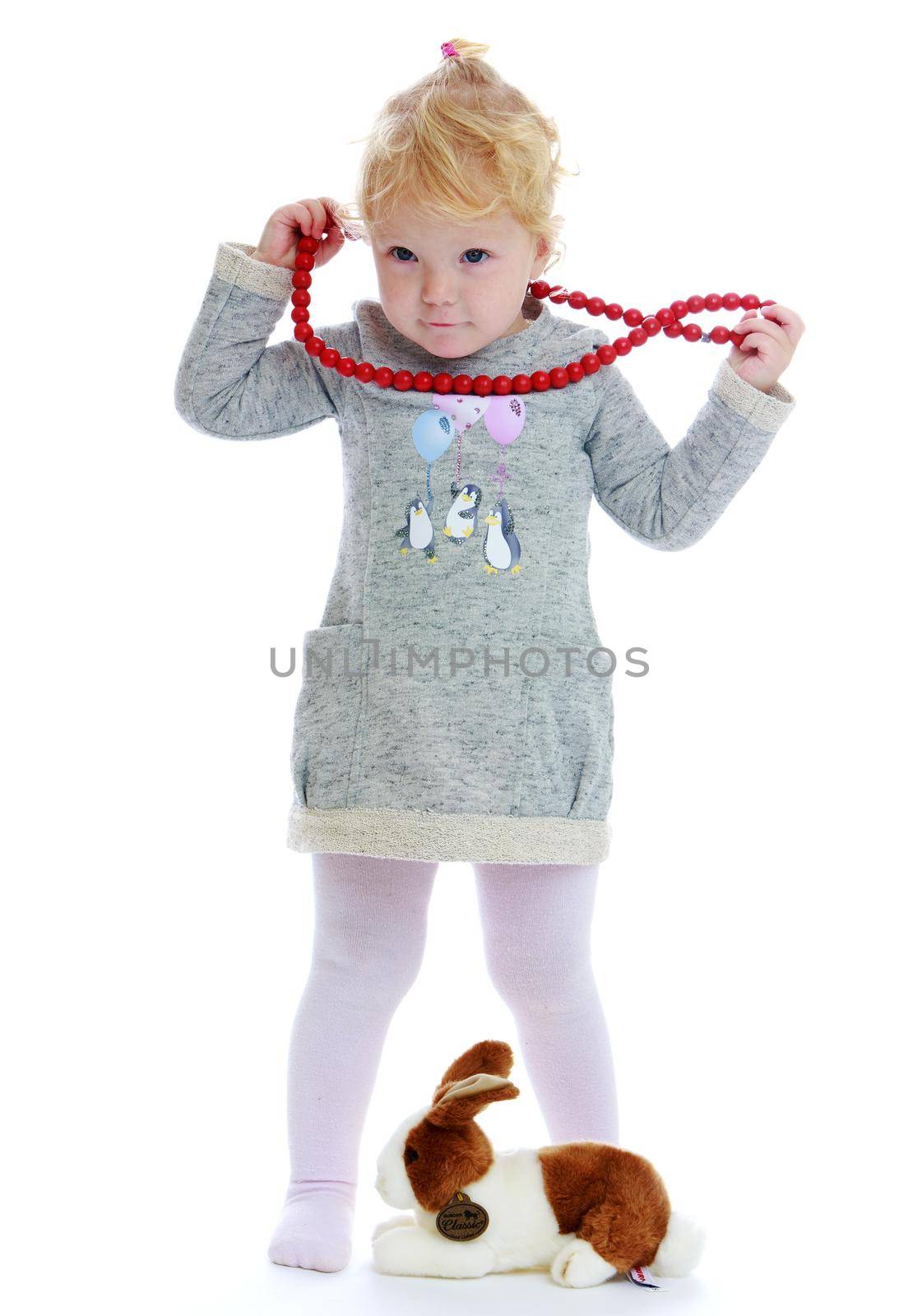 little girl.Two-year-old girl with beads.Isolated on white background.