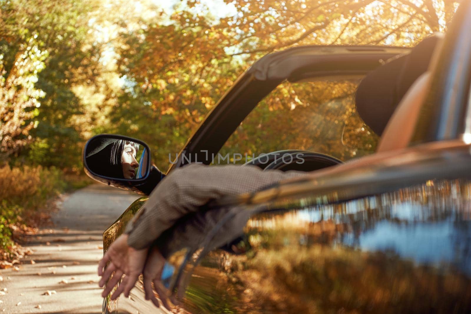 Sexy lady in the roofless car. Stylish woman had fashion haircut. Autumn season.